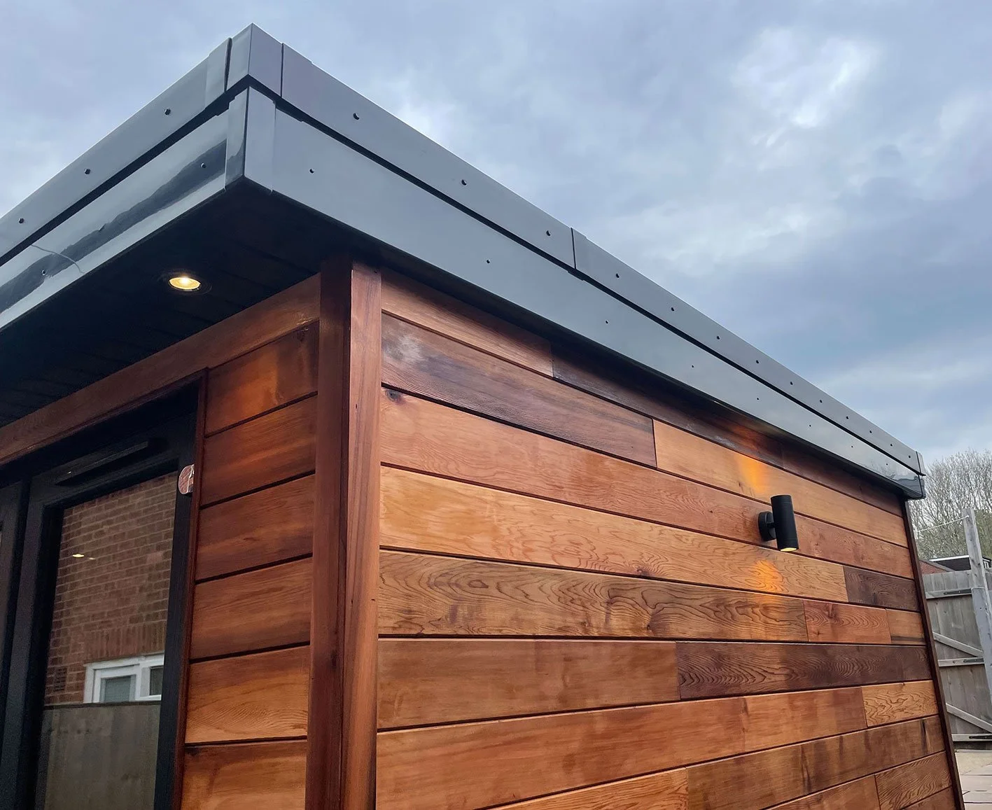  Cozy wooden outdoor office with lit roof. 