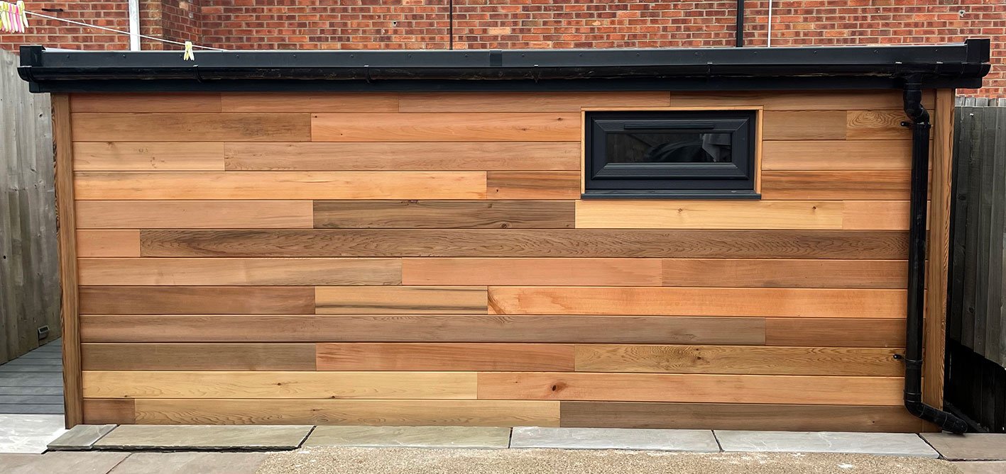  This picture showcases a wooden outdoor office with a window and door, presenting a charming and versatile outdoor structure. 