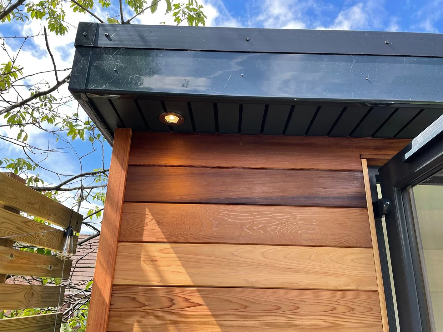  A cozy wooden house with a window and a pitched roof. 