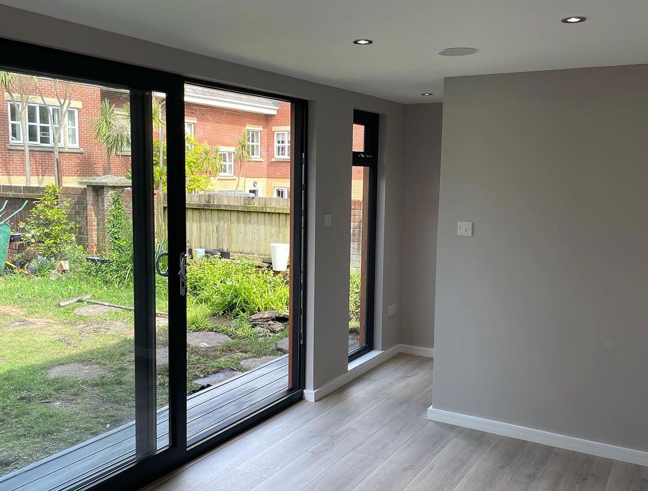  An interior space featuring a sliding door and a sliding glass door, allowing natural light to enter. 