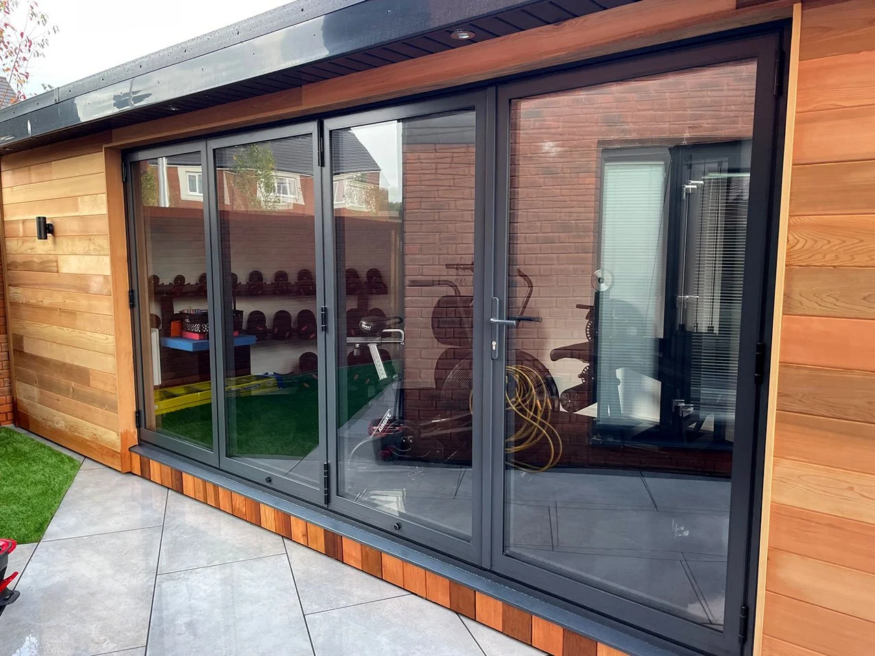  Enhance your outdoor living with a patio showcasing sliding doors and a beautiful wooden deck. 