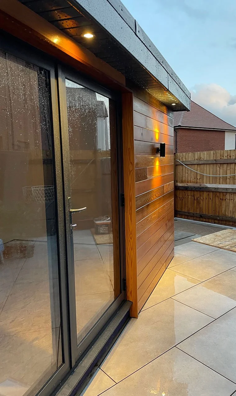  Outdoor patio featuring a wooden deck and sliding door. 