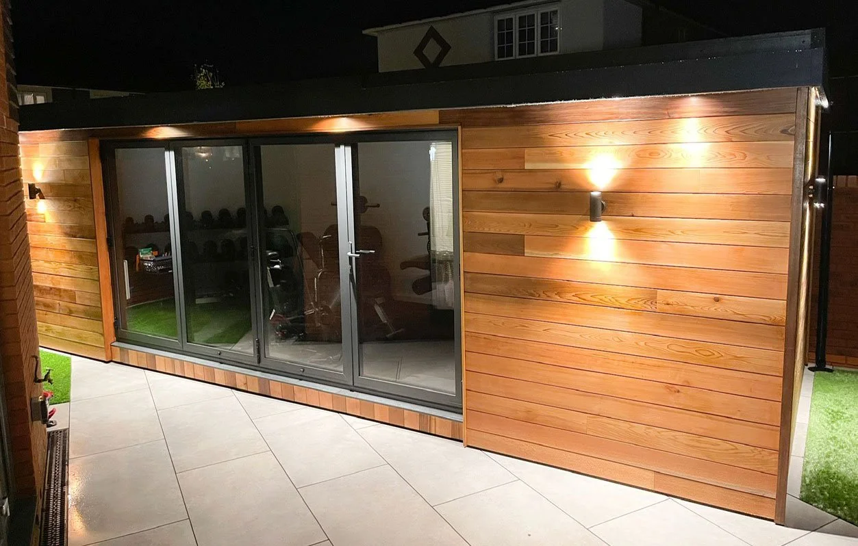  A well-lit garden room with modern design and sliding door access. 