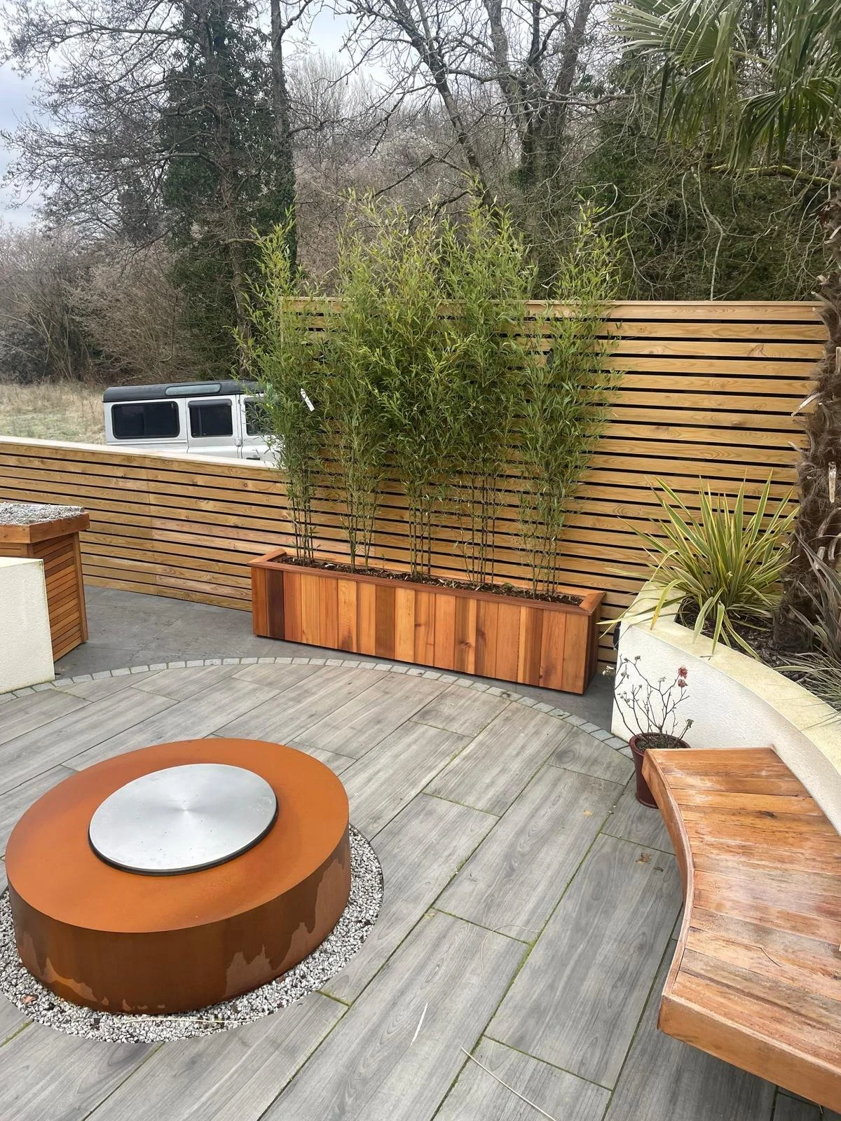 modern-porcelain-patio-with-raised-planters-cardiff-garden-design.jpeg