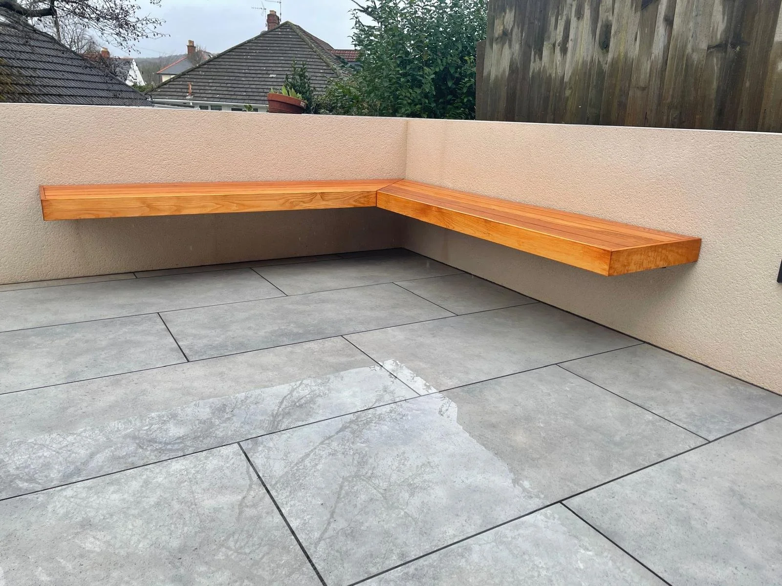 porcelain-patio-with-built-in-timber-seating-newport-landscaping.jpeg