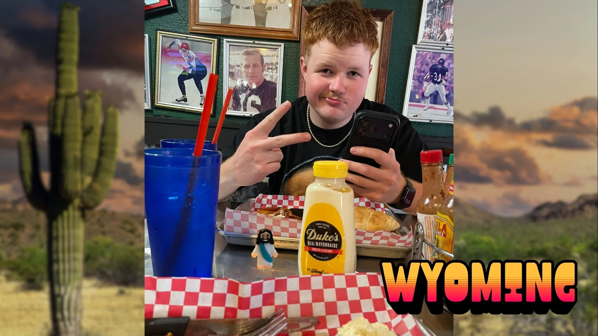 Tiny Jesus figurine on a restaurant table next to Duke's Mayonnaise, with a diner giving a peace sign. Text reads WYOMING.