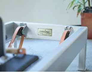 Close-up of a laboratory instrument with electrical connections and a metal nameplate