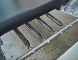 Close-up of metal springs attached to a mechanical or industrial component.