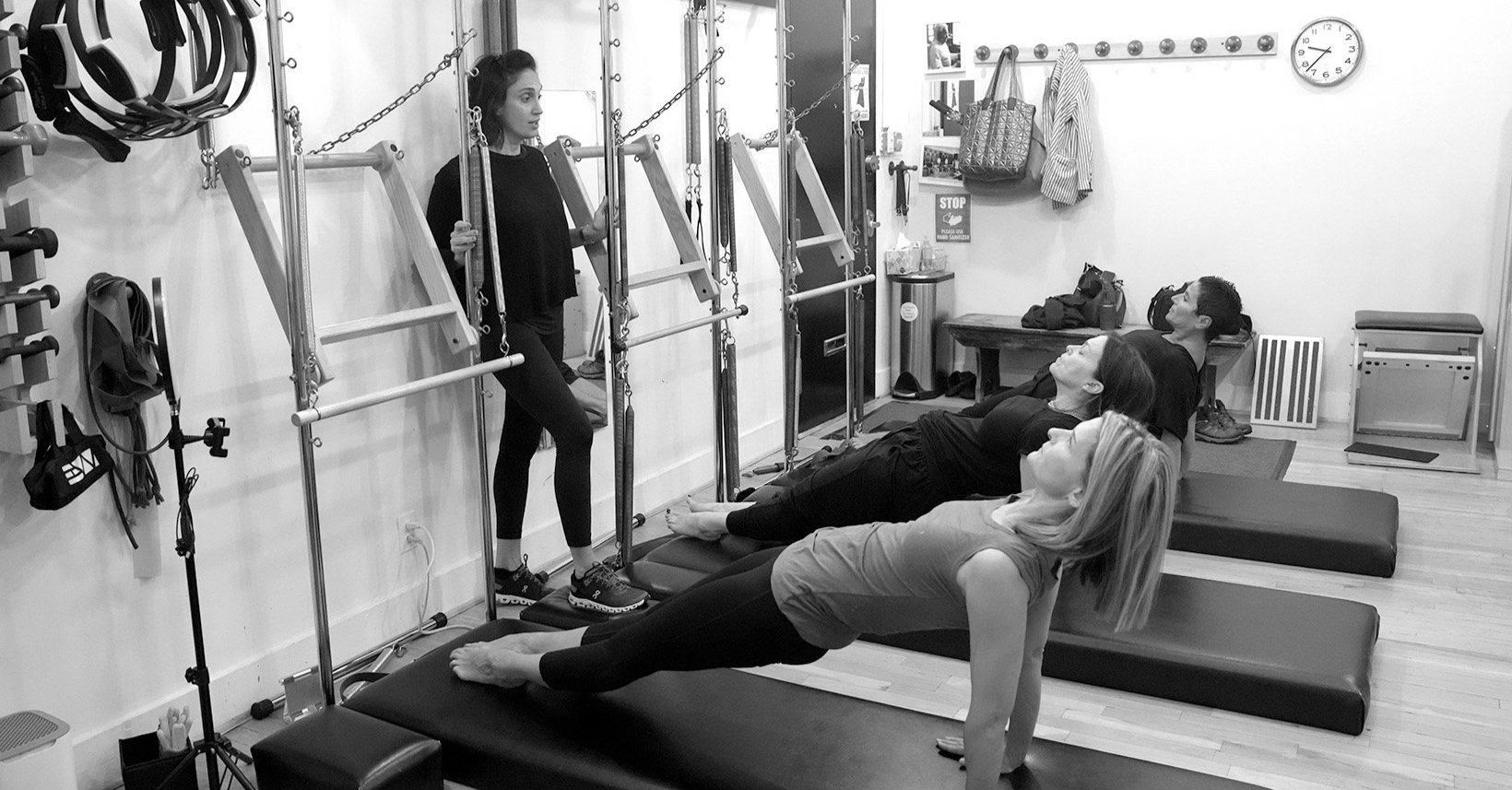 Three women doing matwork pilates with an insturctor.jpg