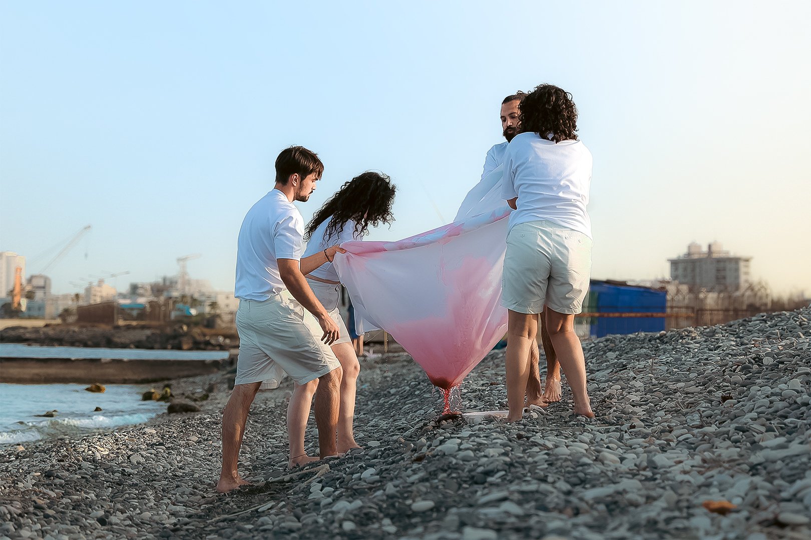 Dis-Displaced installation performance by Eisa Baddour. The artists dip the fabric in wine.