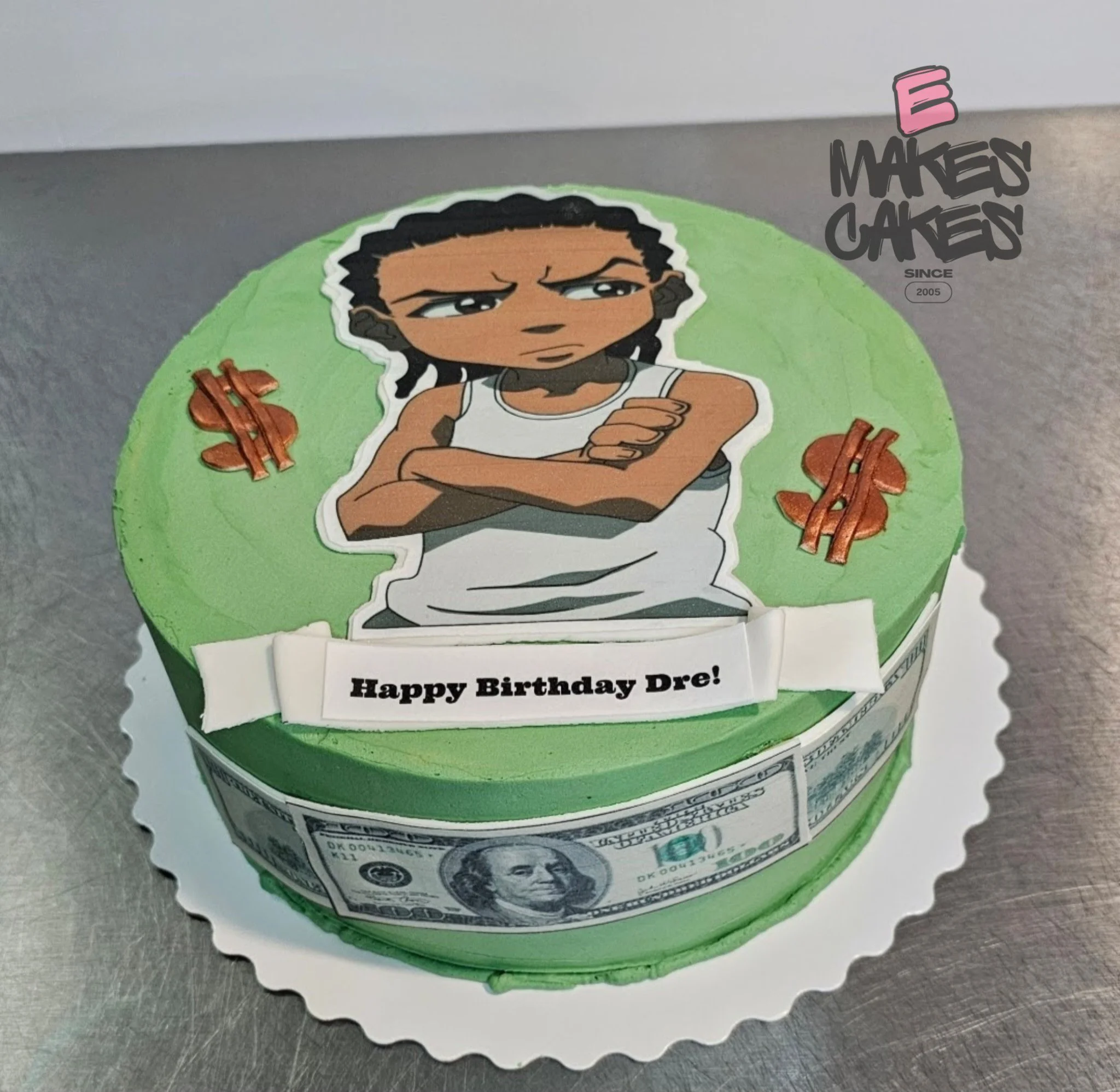 Birthday cake with green frosting, featuring a cartoon with braided hair, crossing h arms with an annoyed expression, surrounded by copper-colored dollar sign decorations. E Makes Cakes
