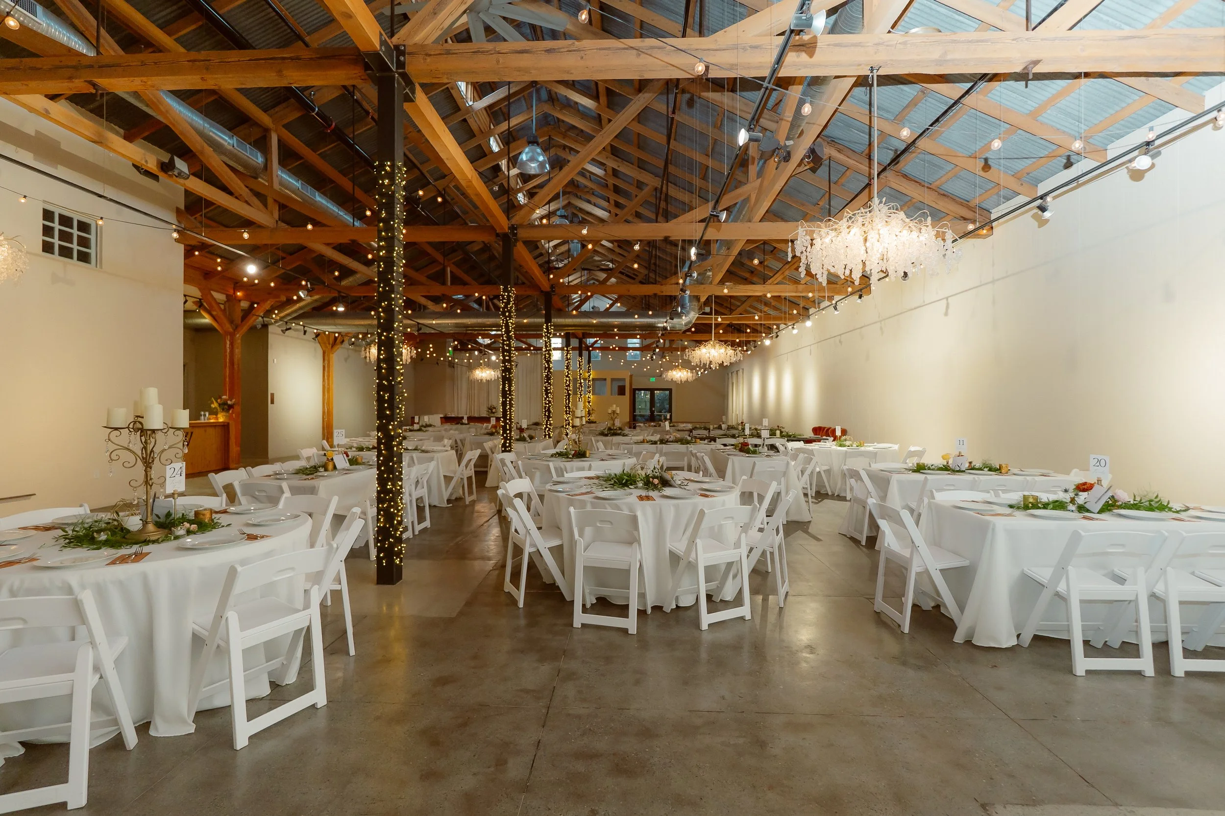 Experience the perfect blend of history and style at The Westport. Our Downtown Chico wedding venue features a grand ballroom where historic wood beams and romantic lighting meet. The original tin barn door provides a unique, cinematic focal point fo