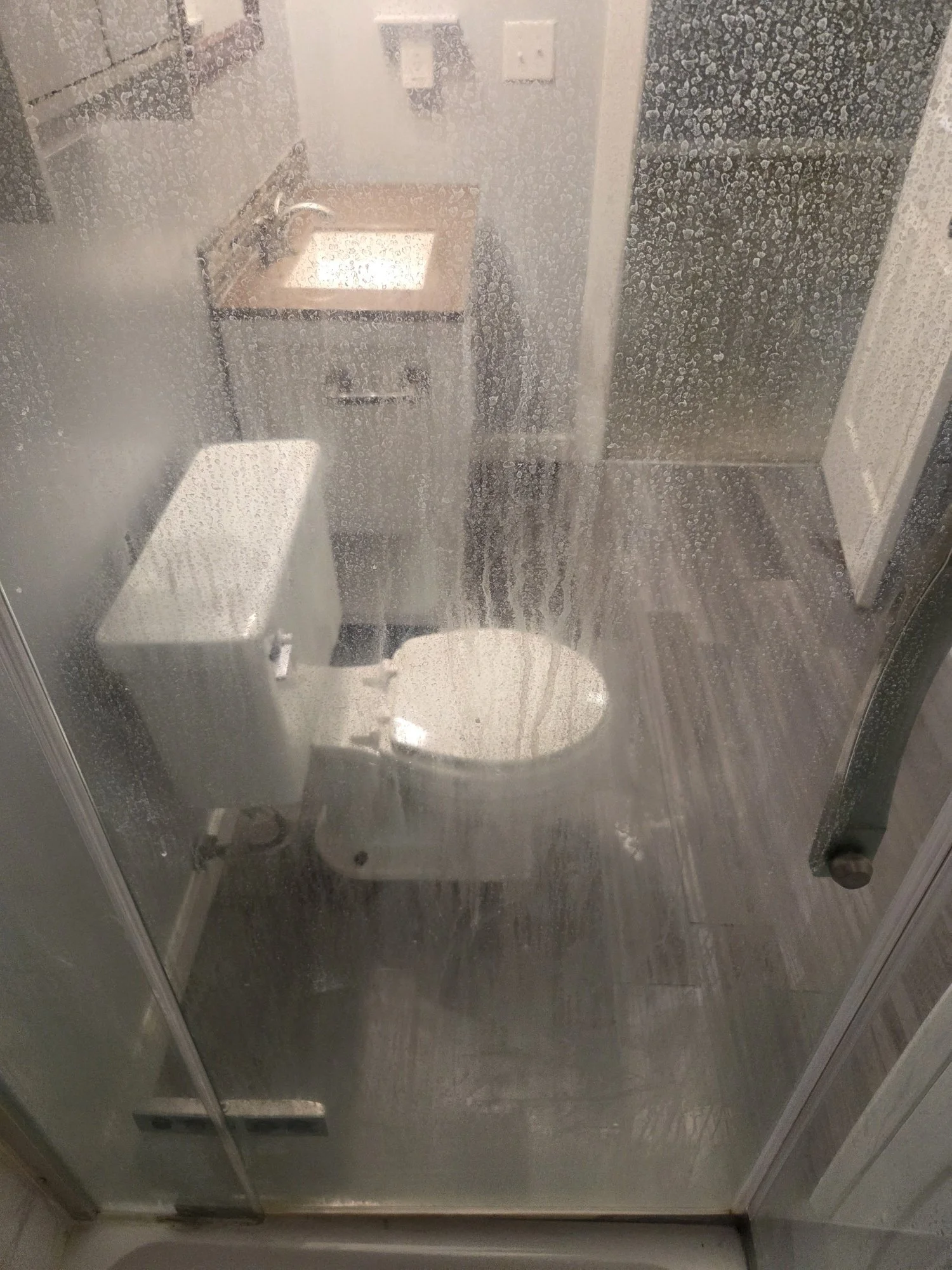 shower glass heavy mineral deposit buildup