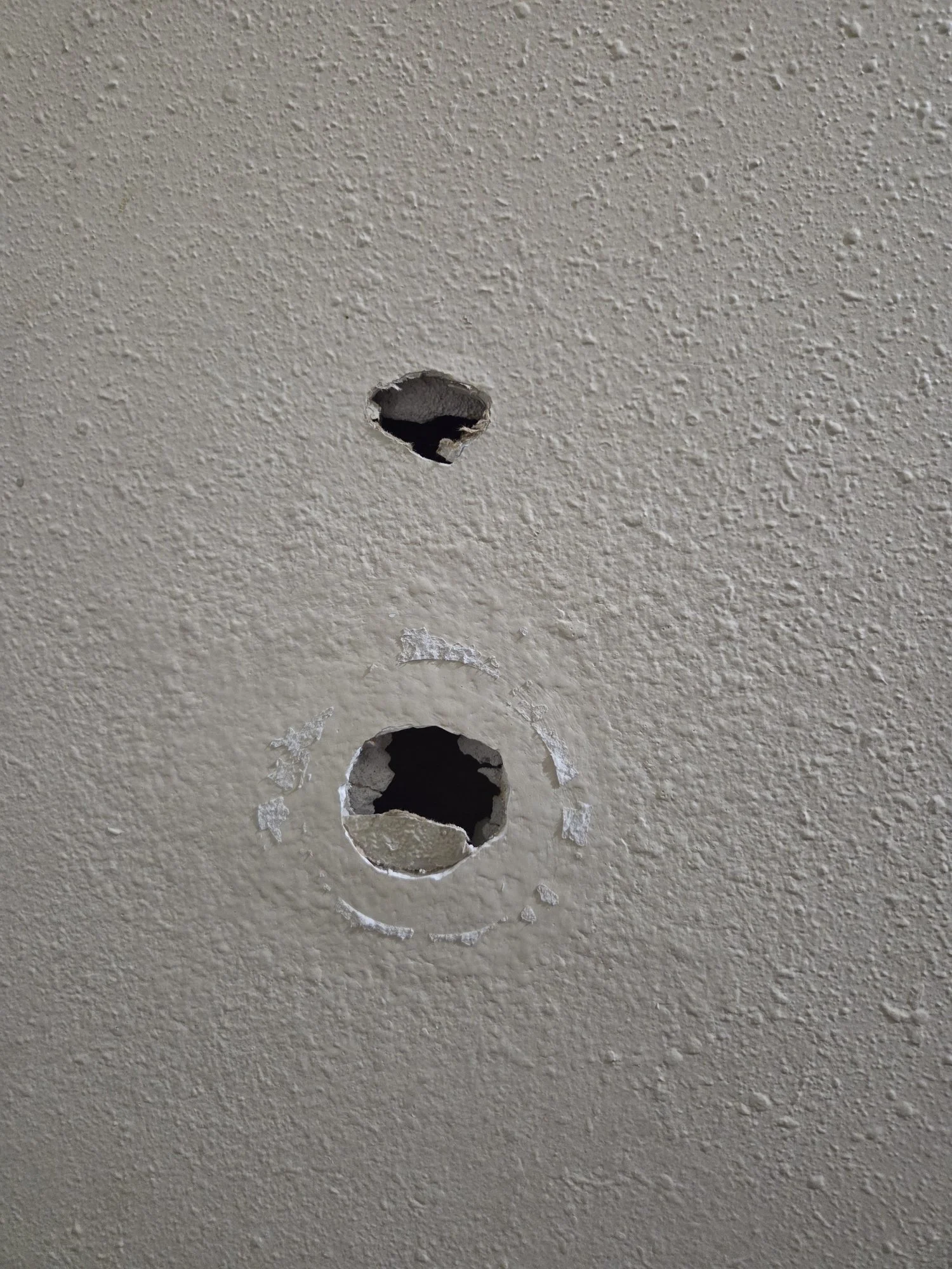 holes in drywall from door handle