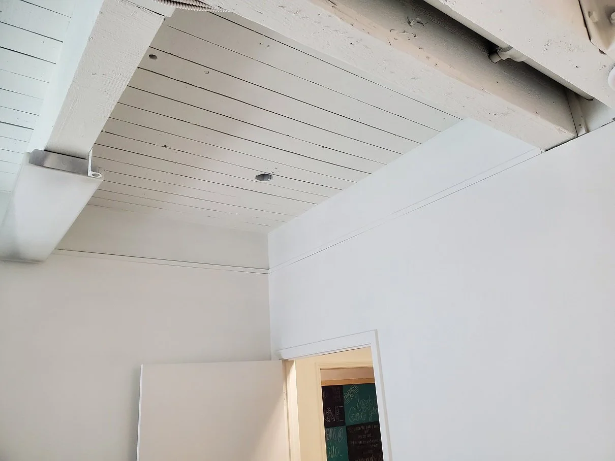wood beam ceiling in home painted white