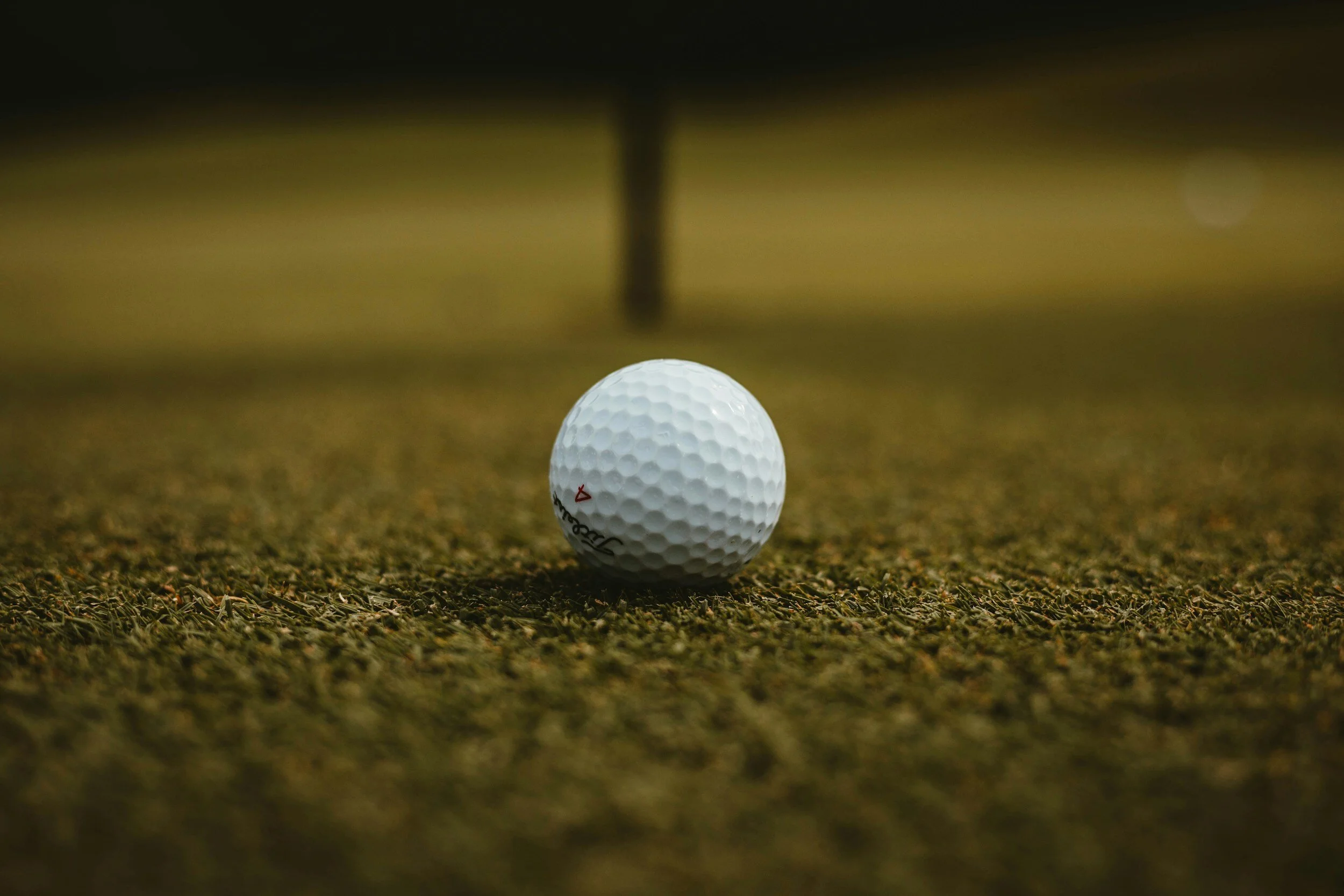 Why is it important to repair ball marks on the green?
