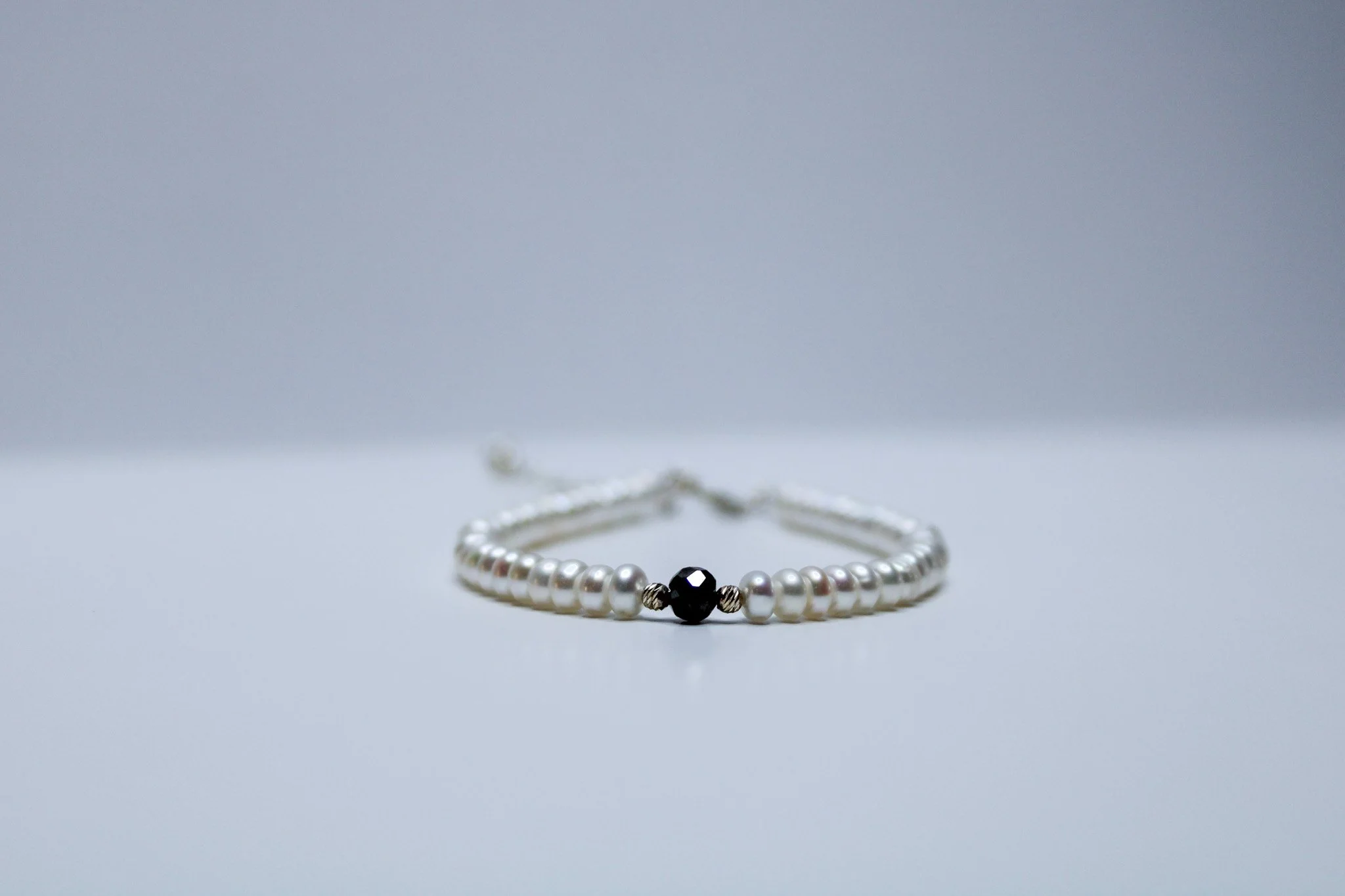 Fresh water button pearl bracelet, faceted black diamond
