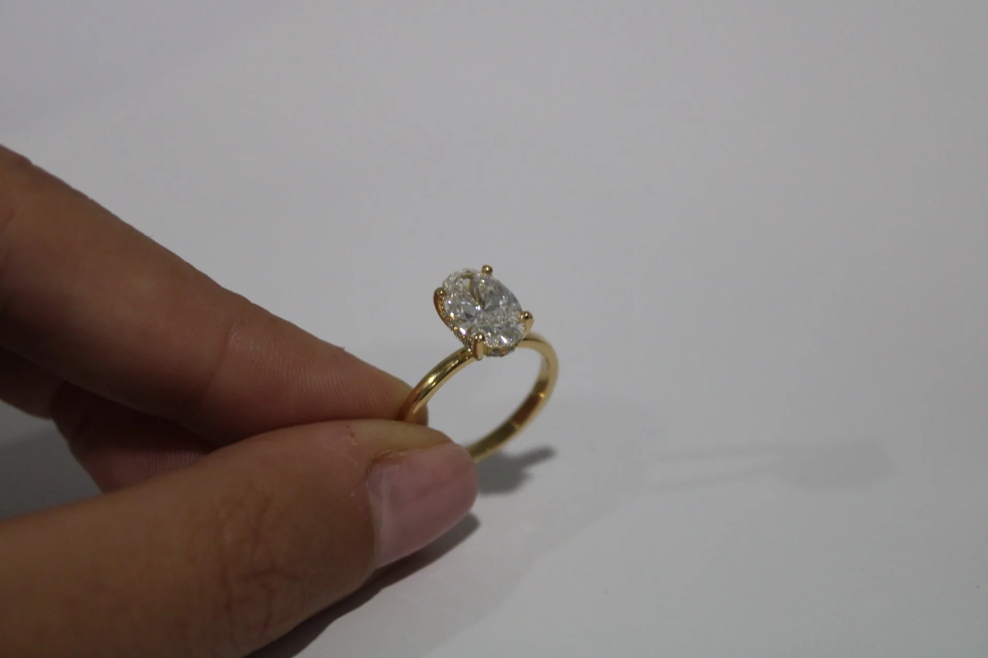 Gold engagement ring with a large central diamond, simple band