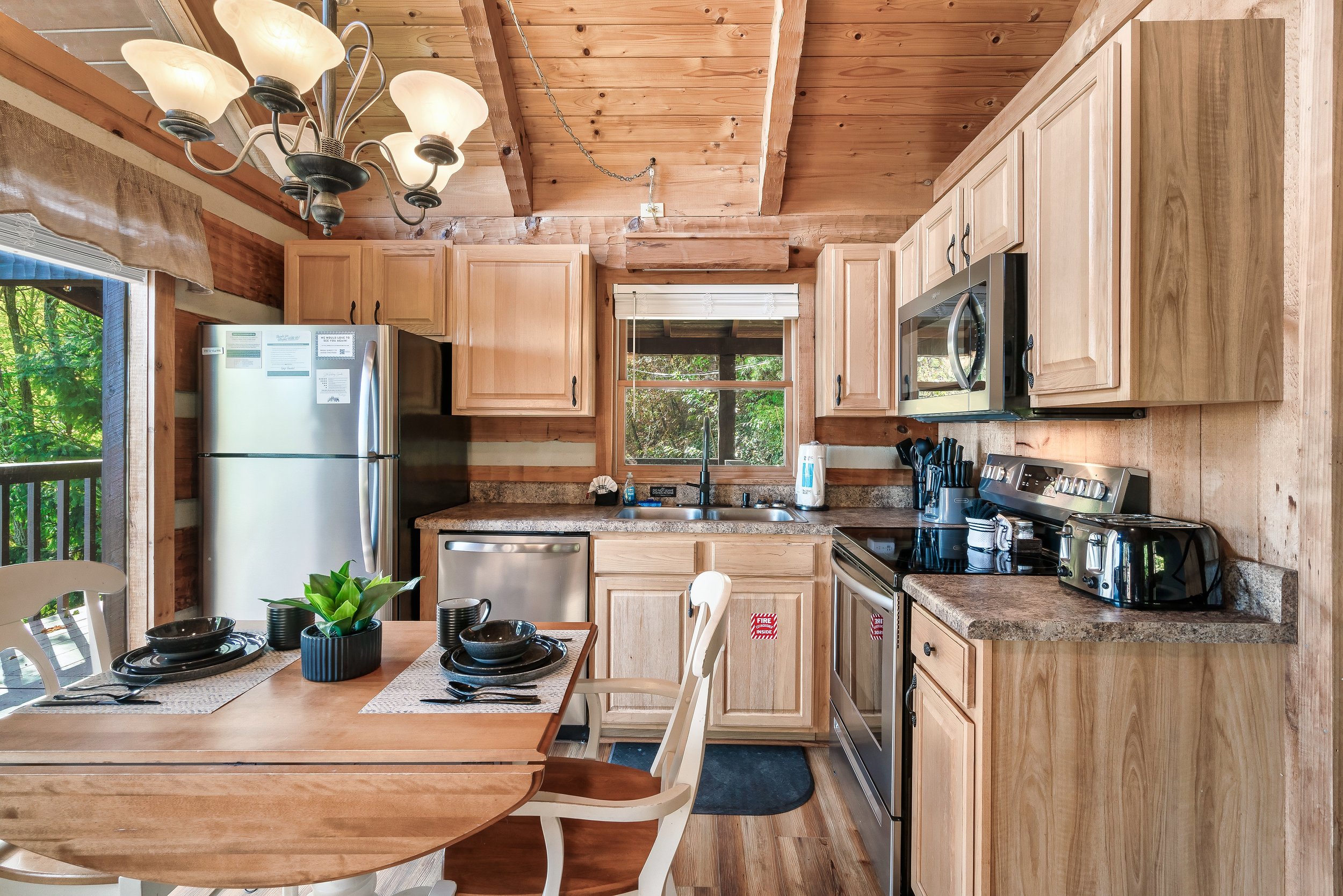 The well-equipped kitchen boasts gleaming stainless steel appliances and a well-stocked coffee bar, inviting you to start your day with a freshly brewed cup in a welcoming, modern space.