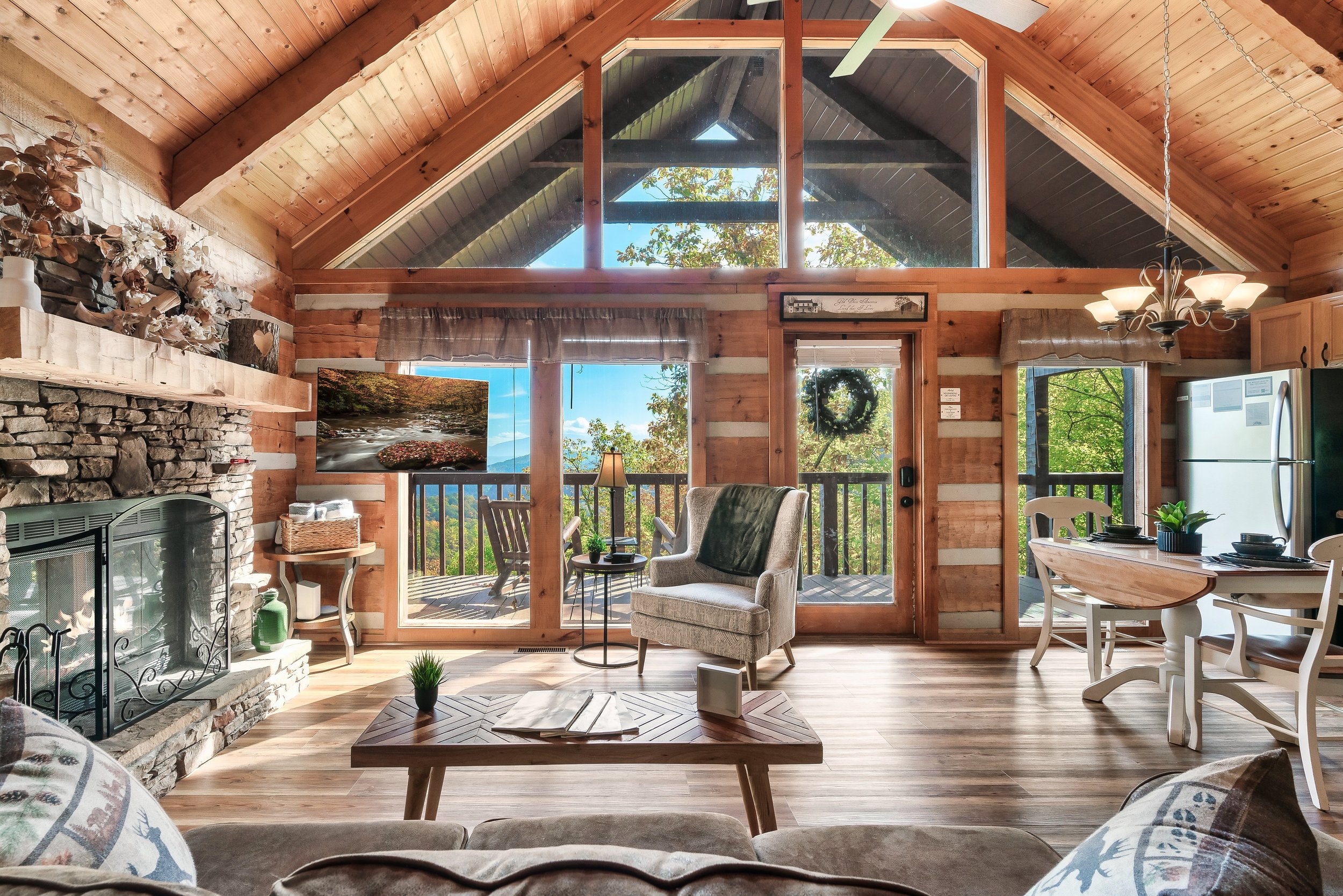 Spend a cool fall afternoon sitting on the couch by the wood-burning fireplace, watching a movie with the smoky mountain views in the background, blending warmth, entertainment, and natural beauty.