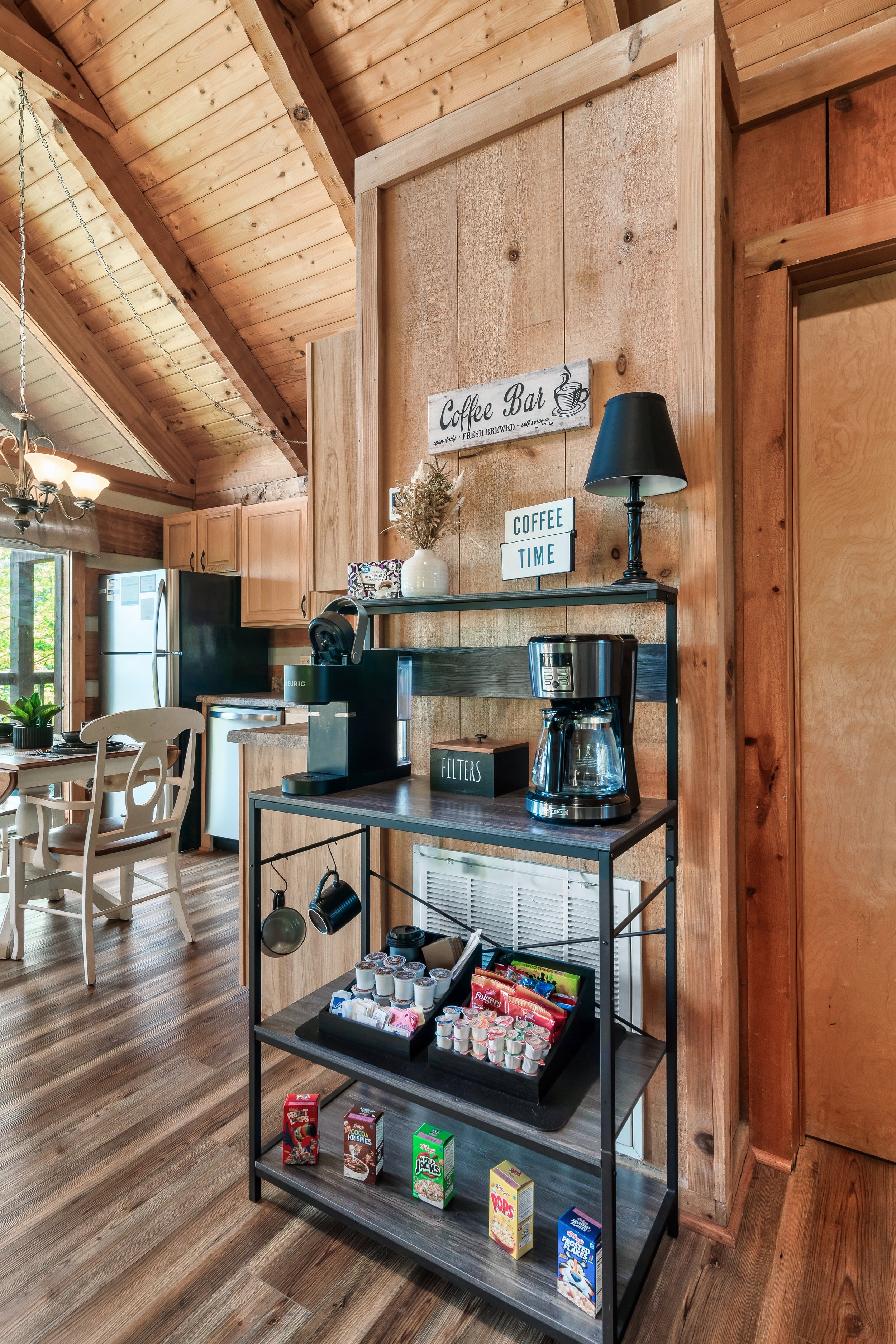 The coffee bar is well-stocked, featuring a Keurig, drip coffee maker, to-go cups, and an assortment of welcome snacks, ready to cater to your every preference and convenience.