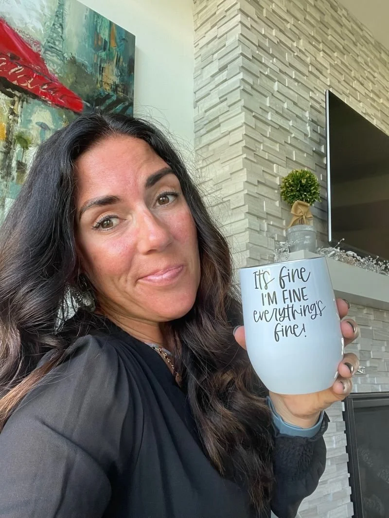 Kelly holding her I'm fine mug