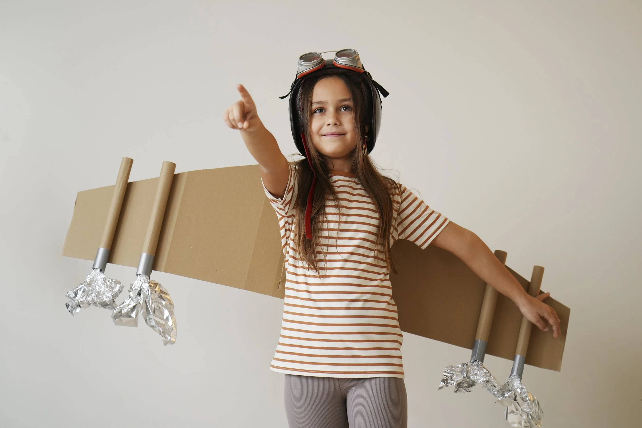 front-view-girl-playing-with-cardboard-wings.jpg