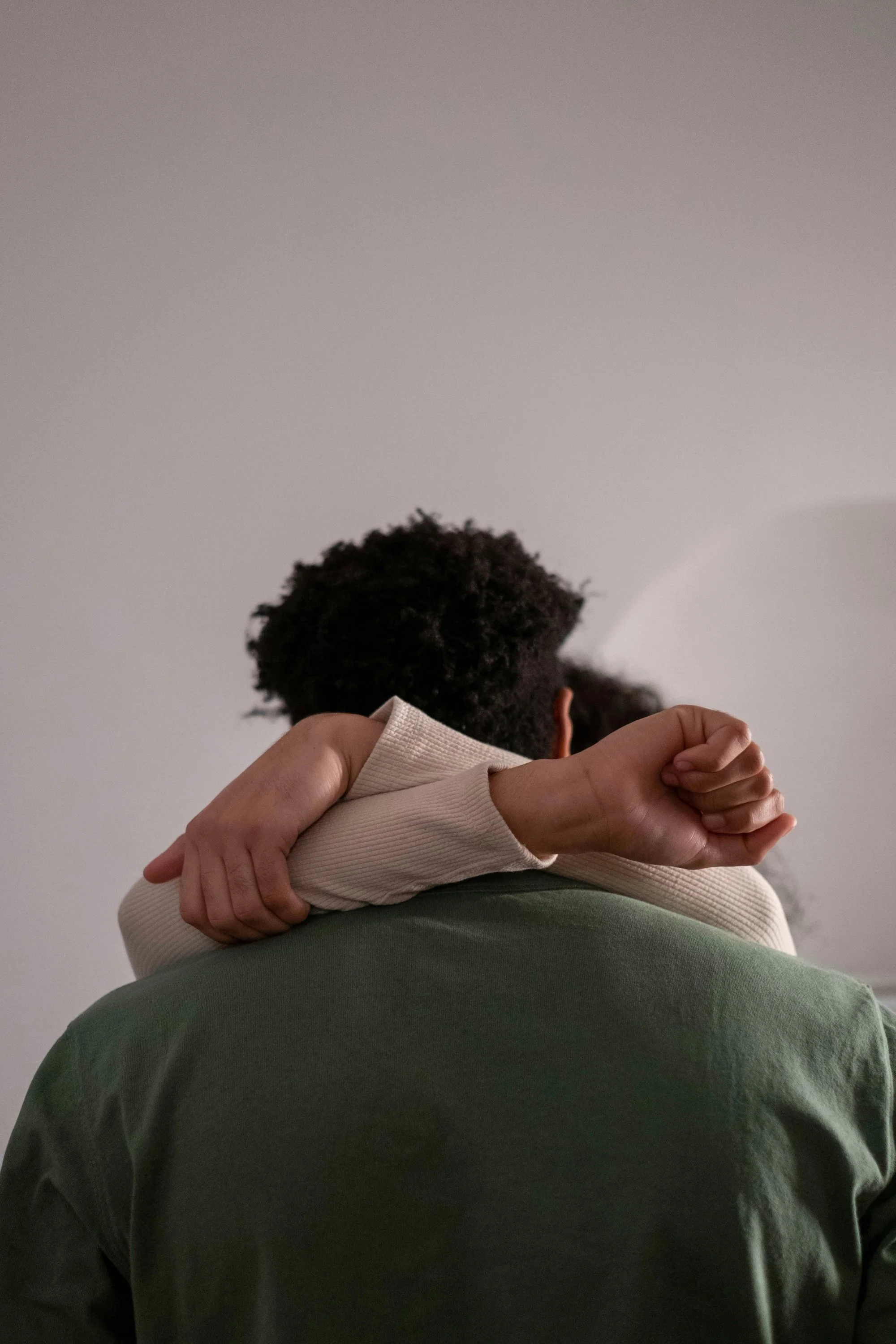 Two people share a quiet, grounding embrace. This image represents the importance of emotional regulation, sensory safety, and connection in Autism-affirming therapy for neurodivergent individuals.