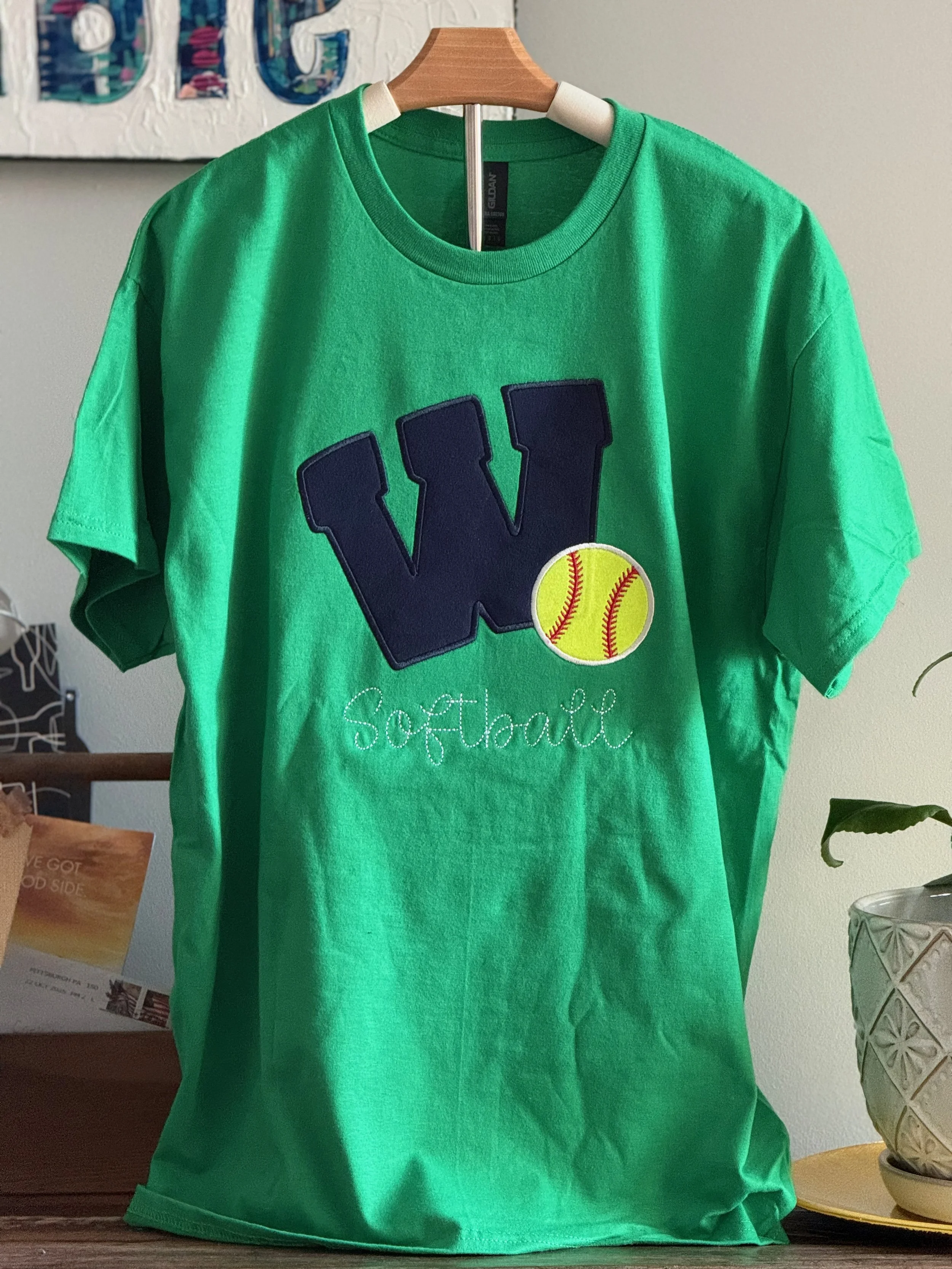 Green t-shirt with Navy Weddington W and neon yellow softball appliqued along with the word Softball in script underneath.