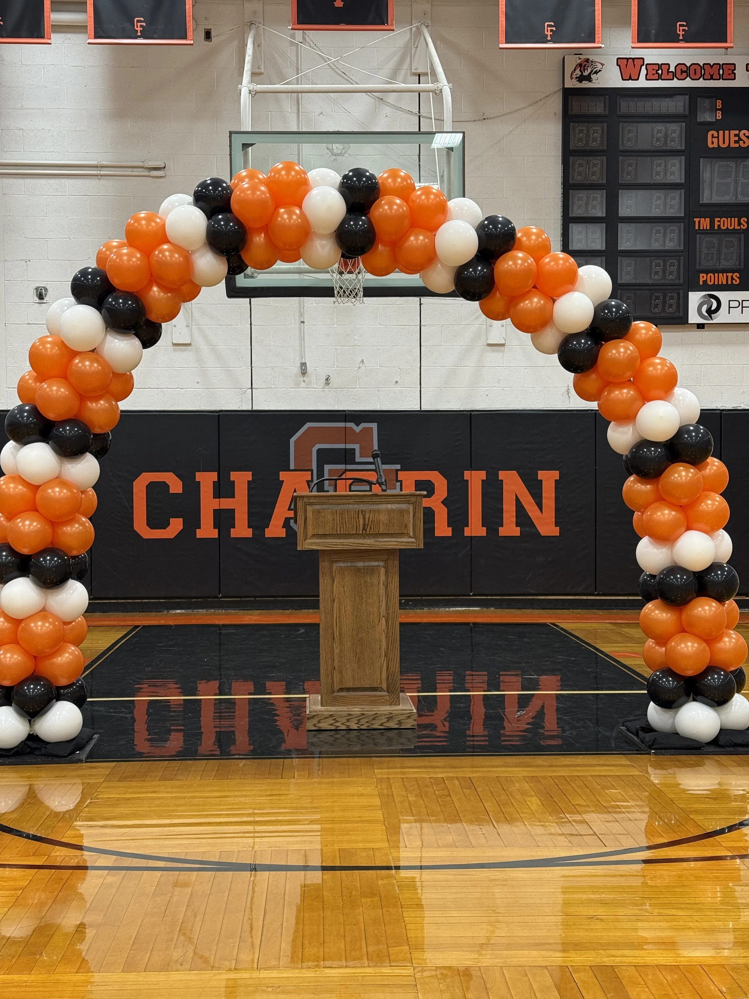 orange, black and white balloon arch in Chagrin Falls gym