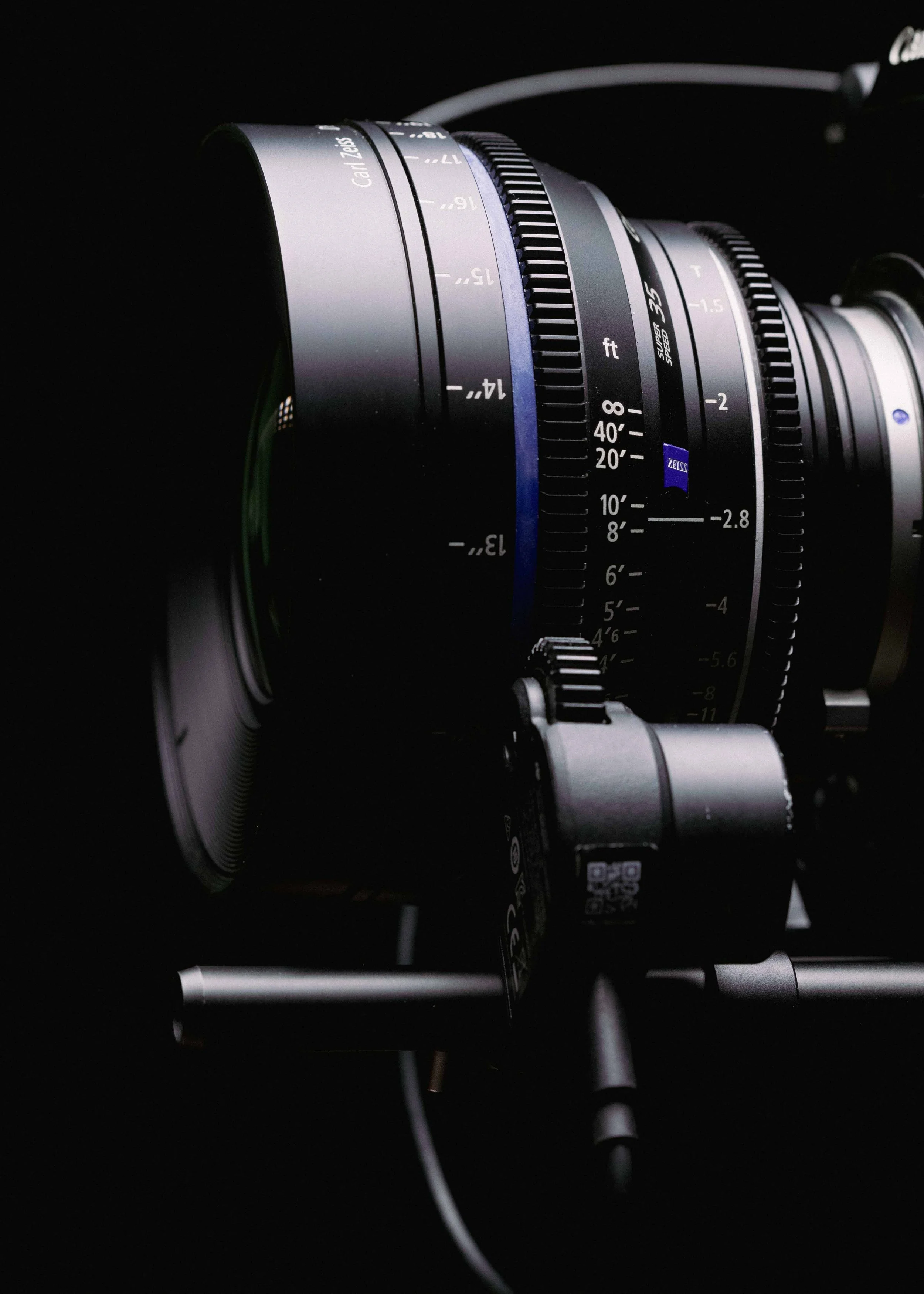 Close-up of a professional camera lens mounted on a tripod