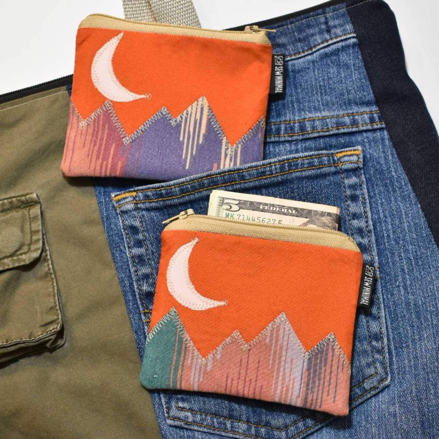 Sew Minimal Upcycled Fabric Handmade In USA Crescent Moon Orange Sky Tiny Pouch Displayed With Jeans
