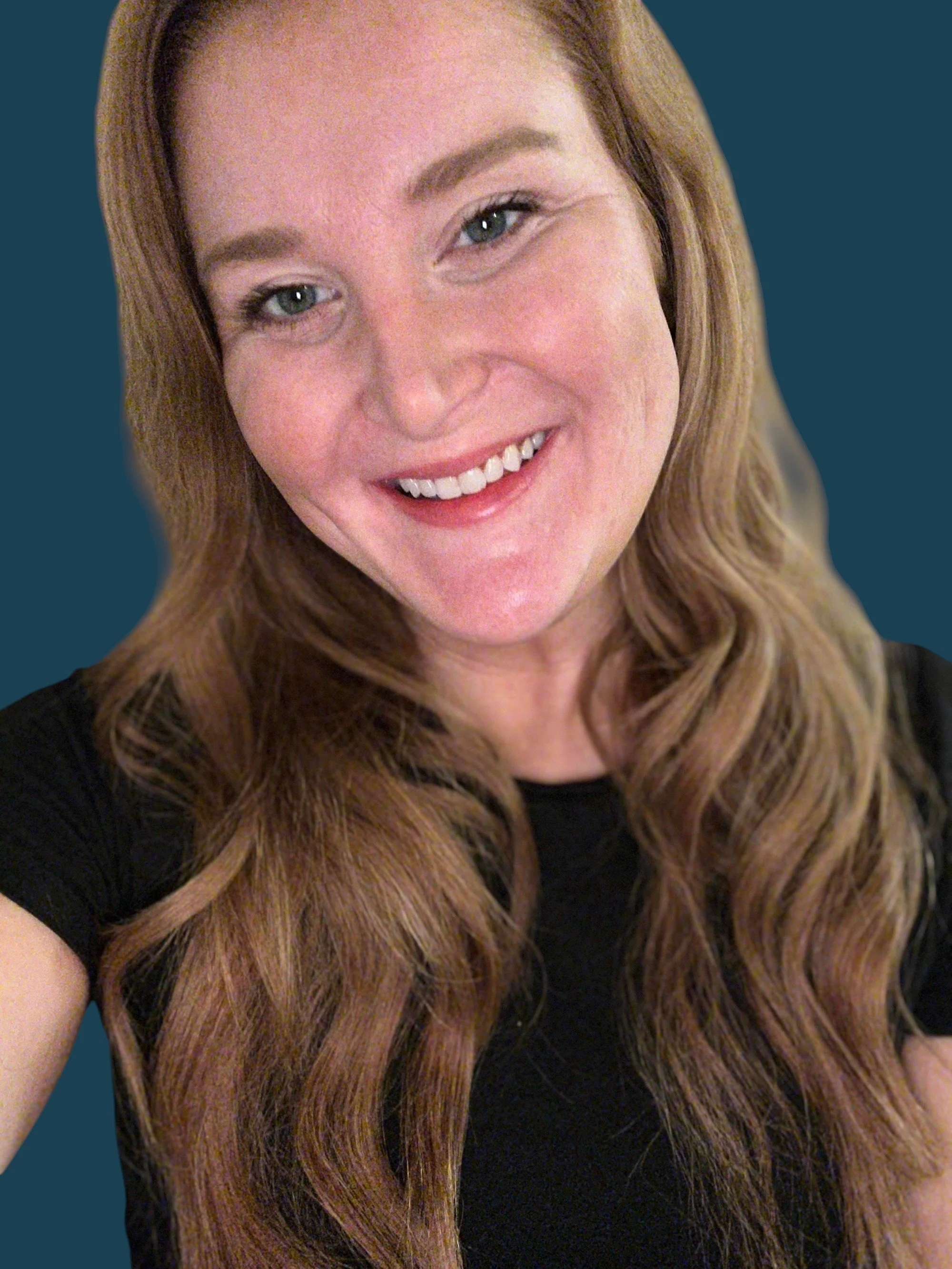 Young woman with auburn hair and dark blue background