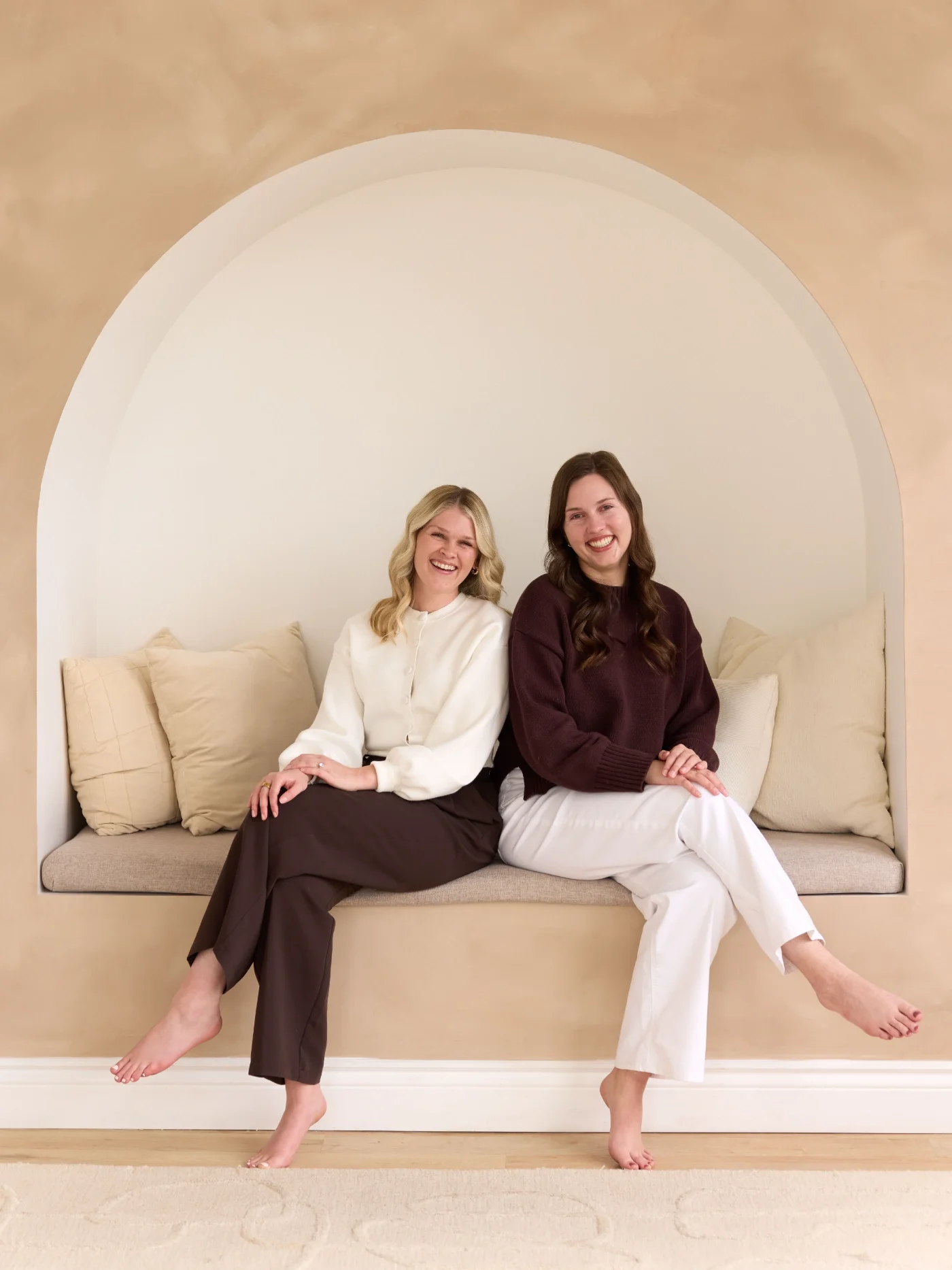 two therapists sitting beside one another on couch