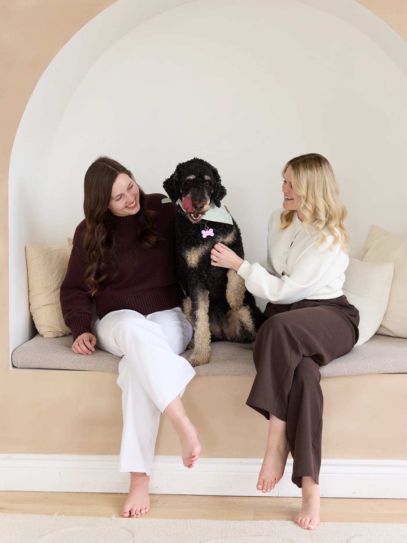 Two therapists sitting on couch with dog