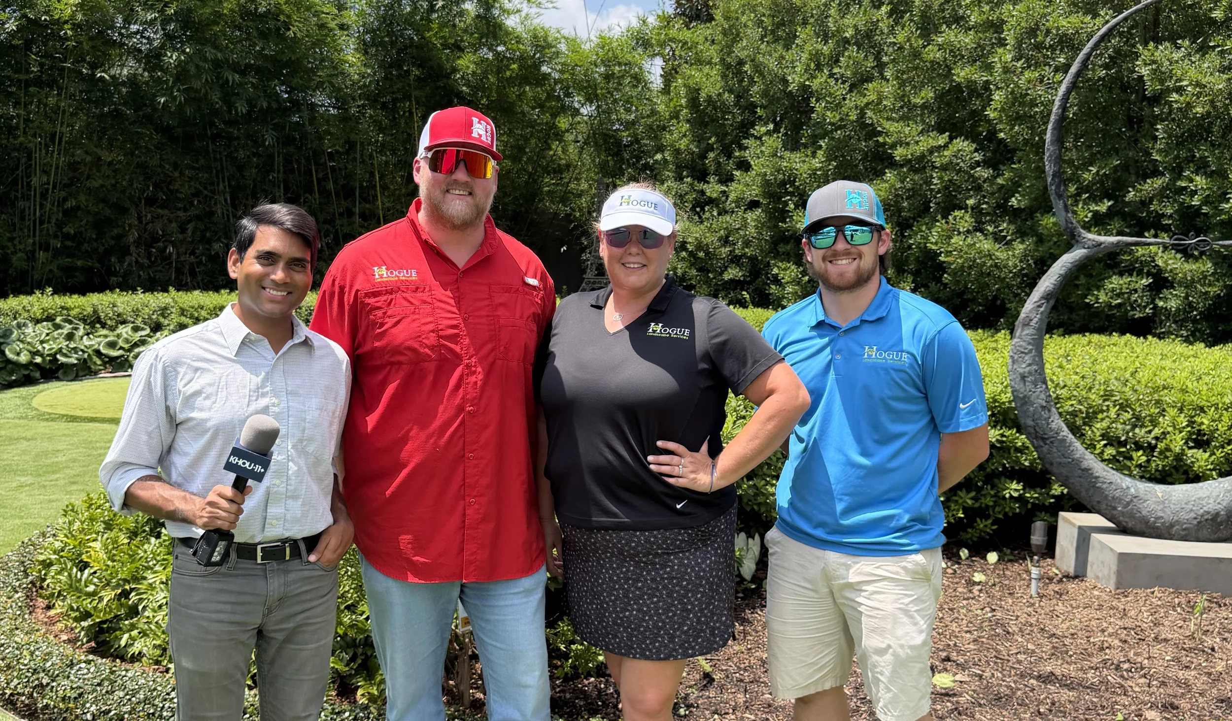 Hogue Landscape Services crew discussing heat safety practices during Houston summer temperatures.