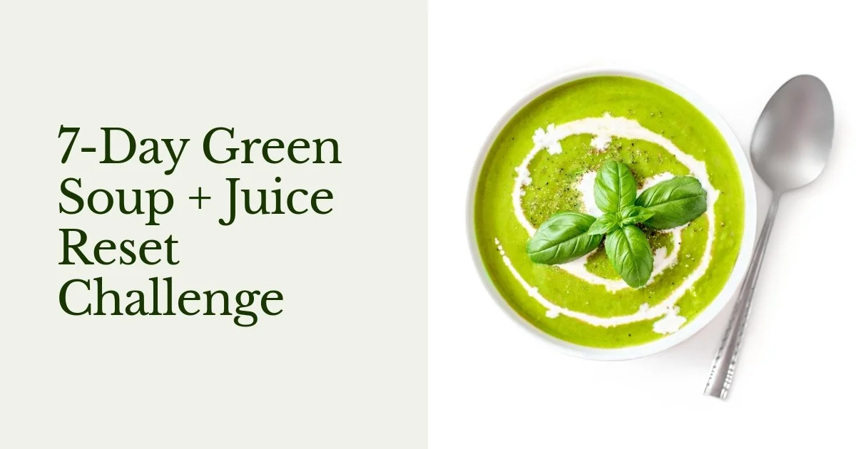 A bowl of green soup garnished with fresh basil leaves, with a spoon placed beside it.