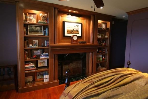 Wood-paneled room with a built-in bookcase and fireplace