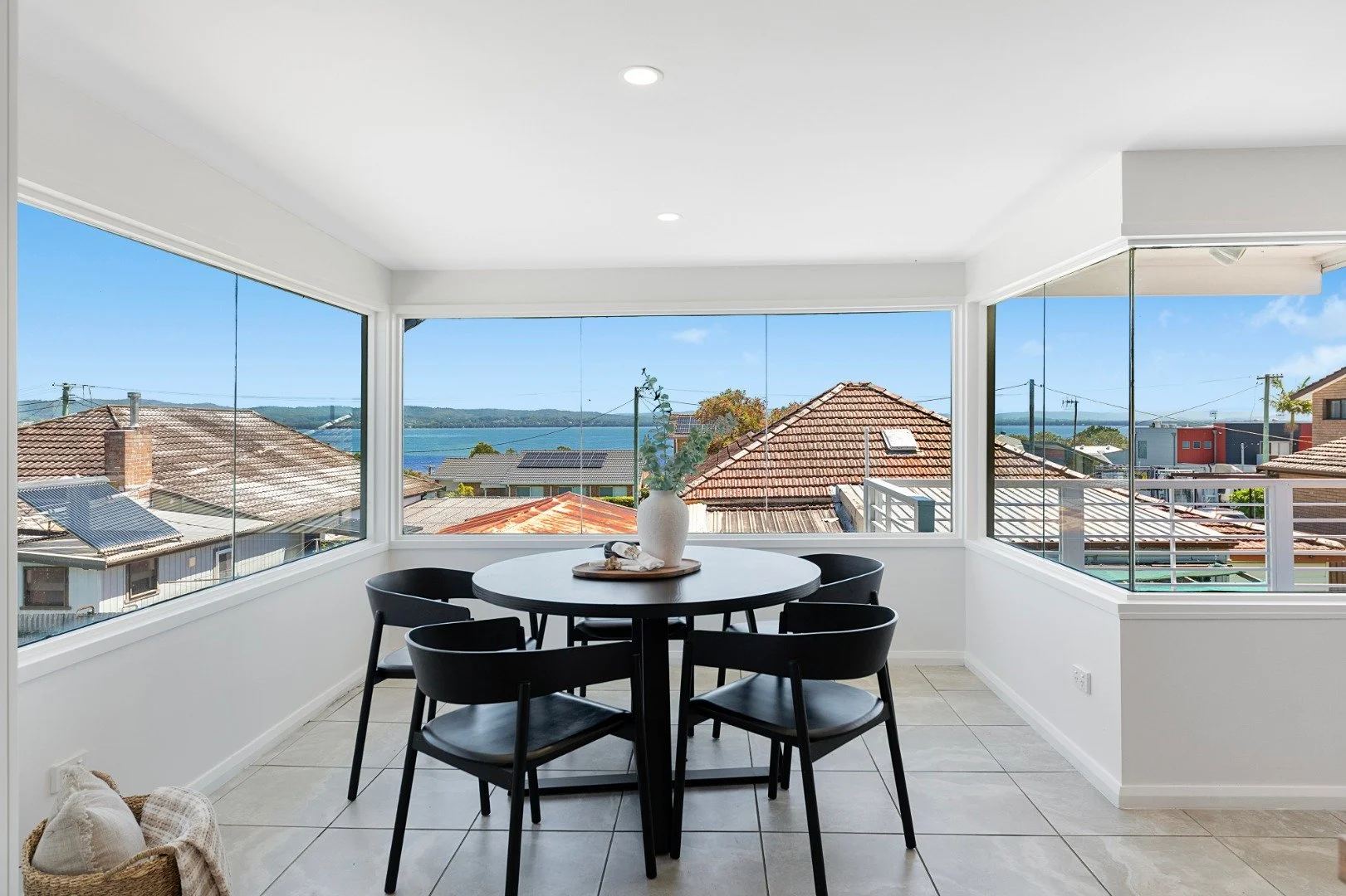 A calm waterfront setting where architecture and water sit in quiet balance. This dining area is designed to frame the environment, making the shifting tides part of the home&rsquo;s interior. It is an exterior-facing space that feels confident and n