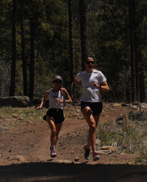 Two of our coaches running on a forest trail