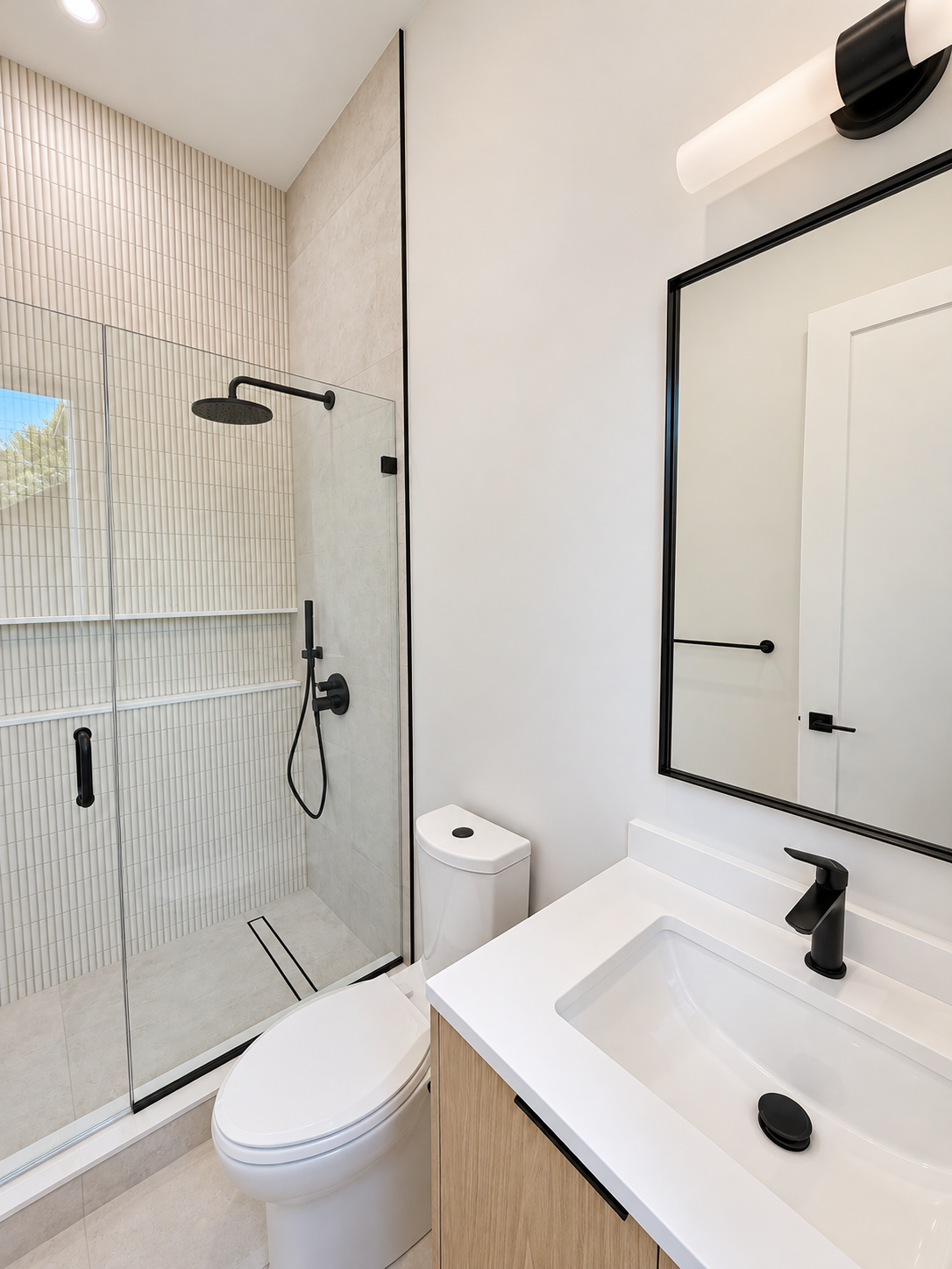 Sunlit Bathroom with Black-Framed Shower-8.png