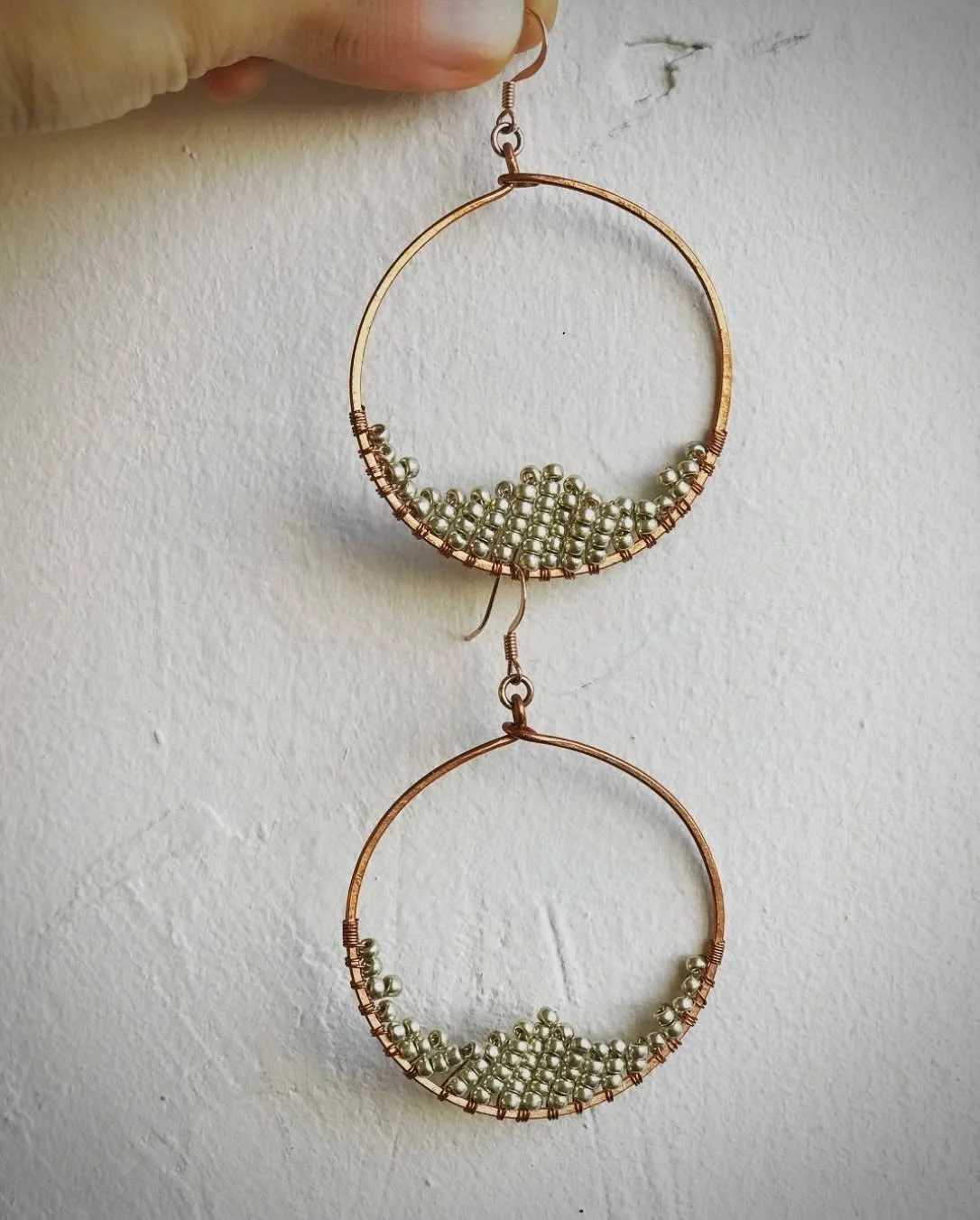 Handcrafted copper hoops with golden bead accents. #handmadejewelry #jewelry #copperjewelry #goldbeads #rusticjewelry #bohofashion