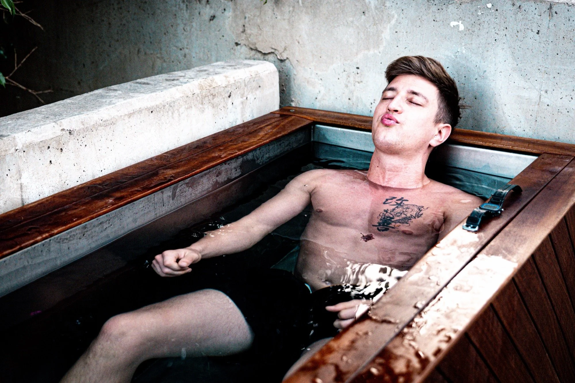 Athlete lying back in a Pagoc Health ice bath during a recovery session