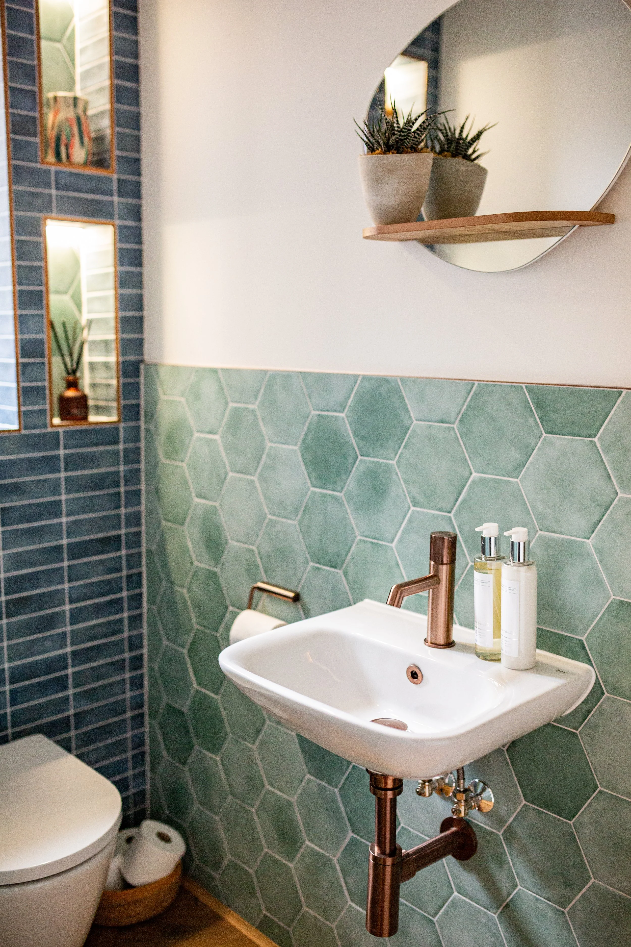 Cloakroom blue and green tiles, bronze hardware