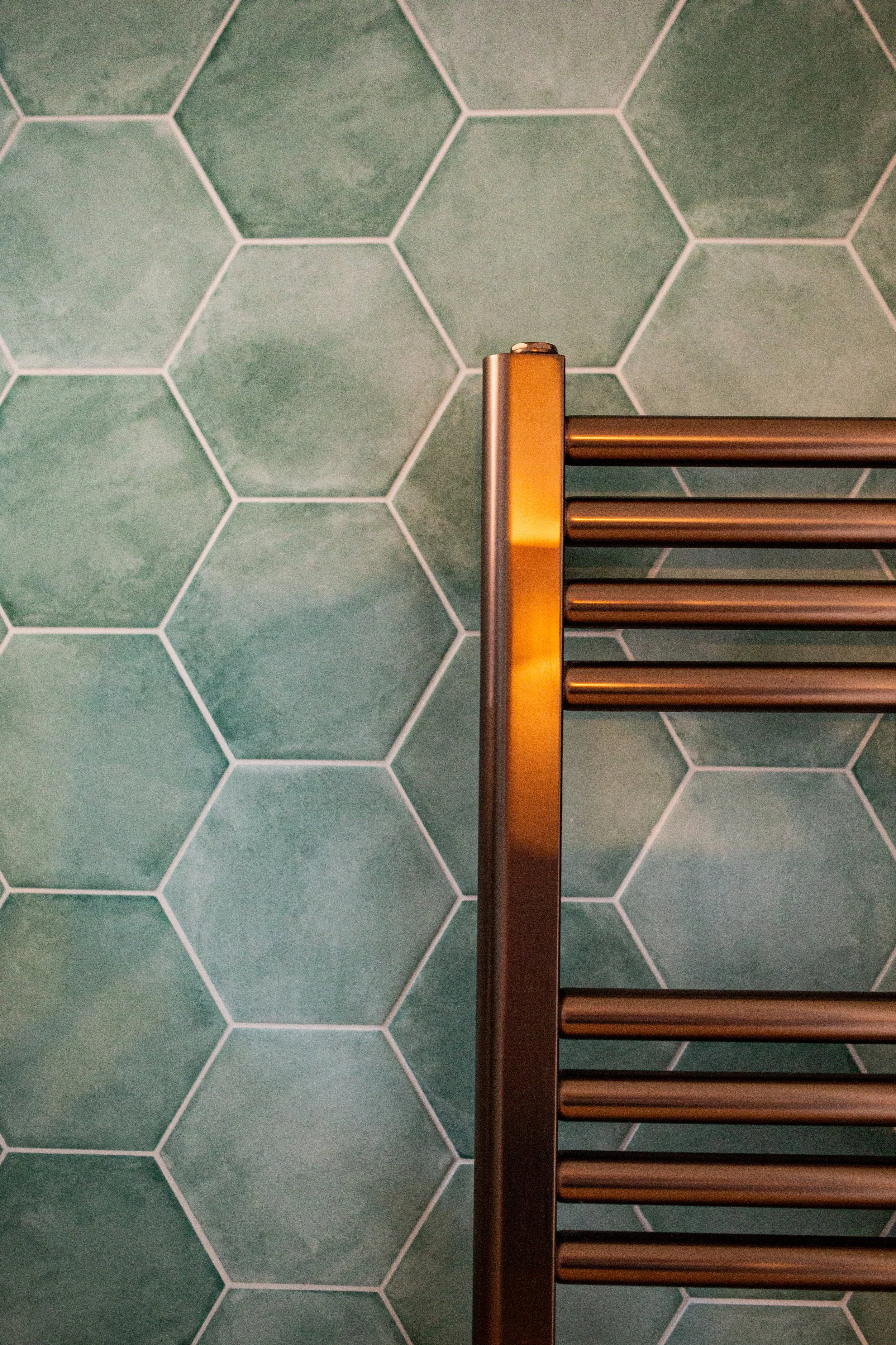 green hexagonal tiles bronze radiator cloakroom design