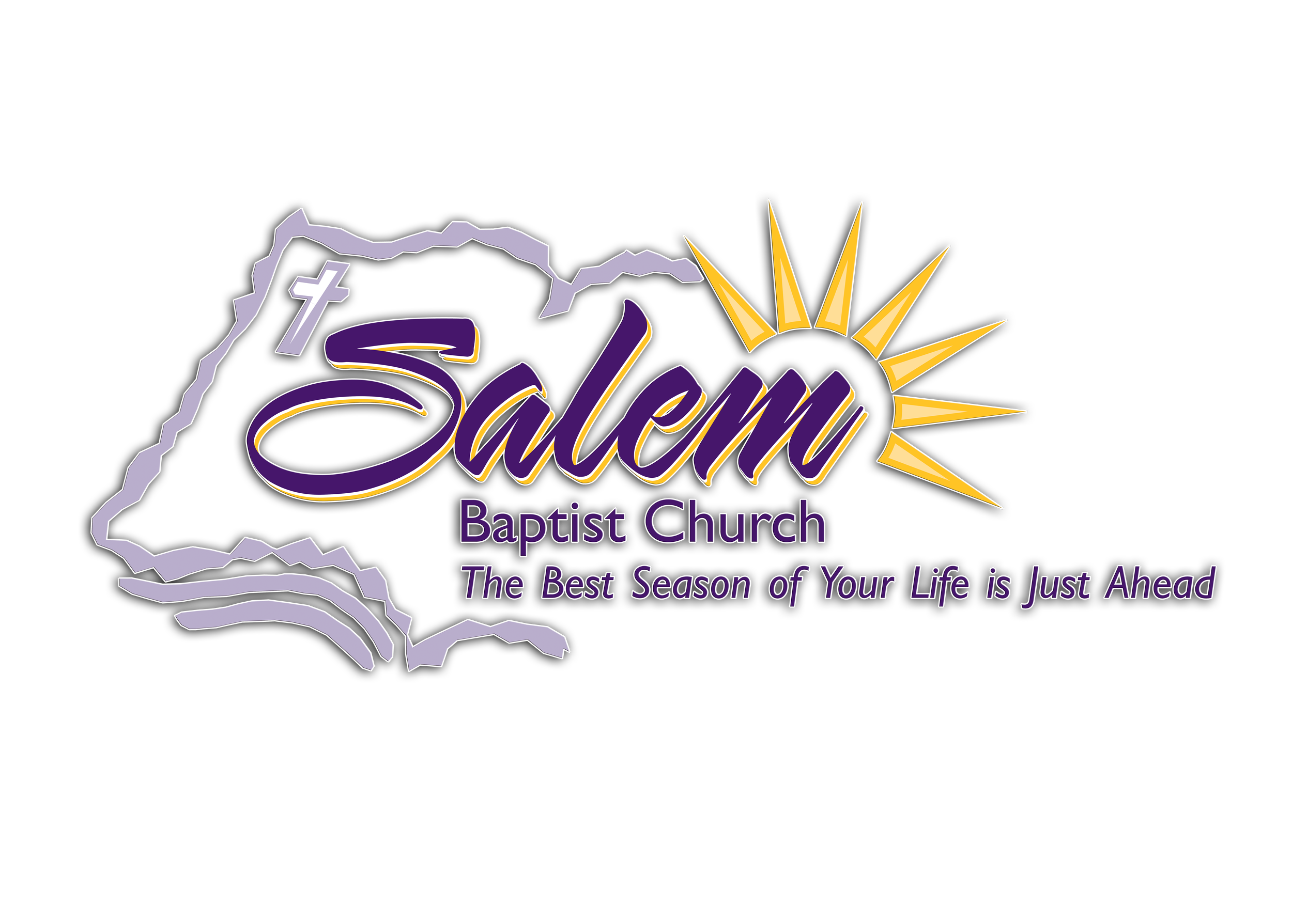 A man in a black suit and tie, with a shaved head and goatee, standing indoors.