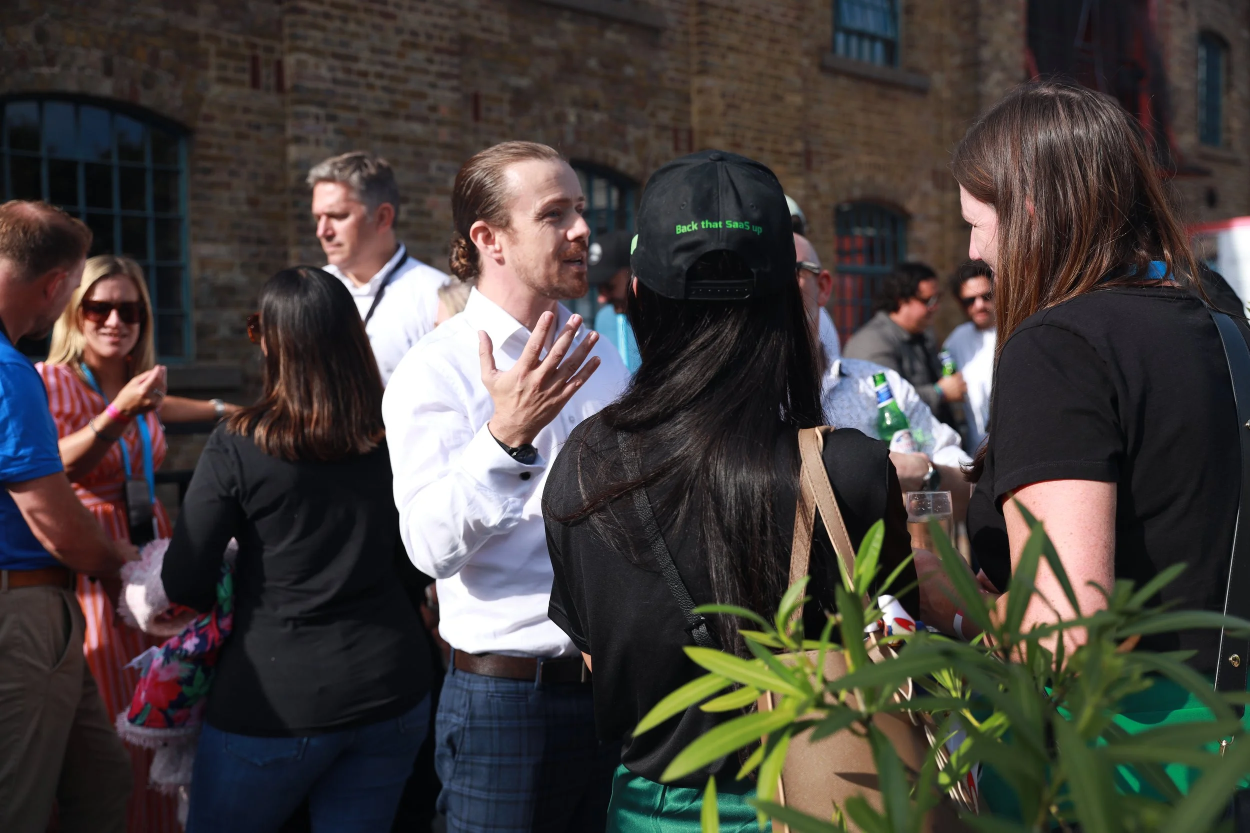 Just Saul engaging guests in conversation at a corporate event in London