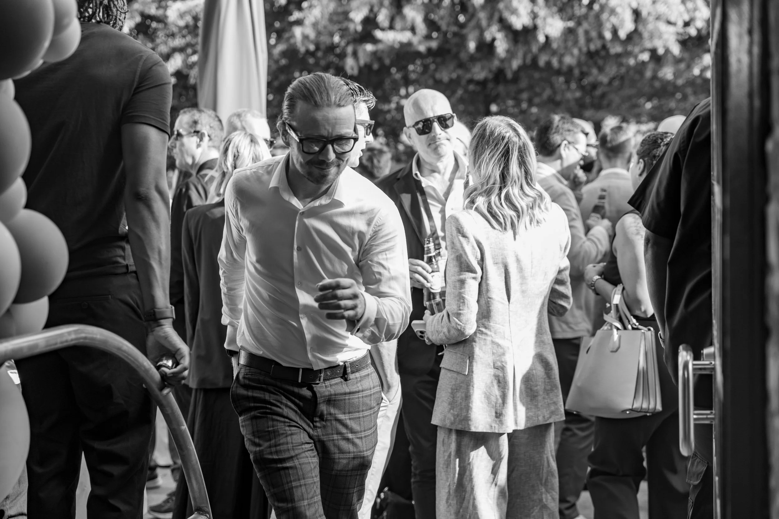 Just Saul walking through a crowd of guests at a corporate event reception