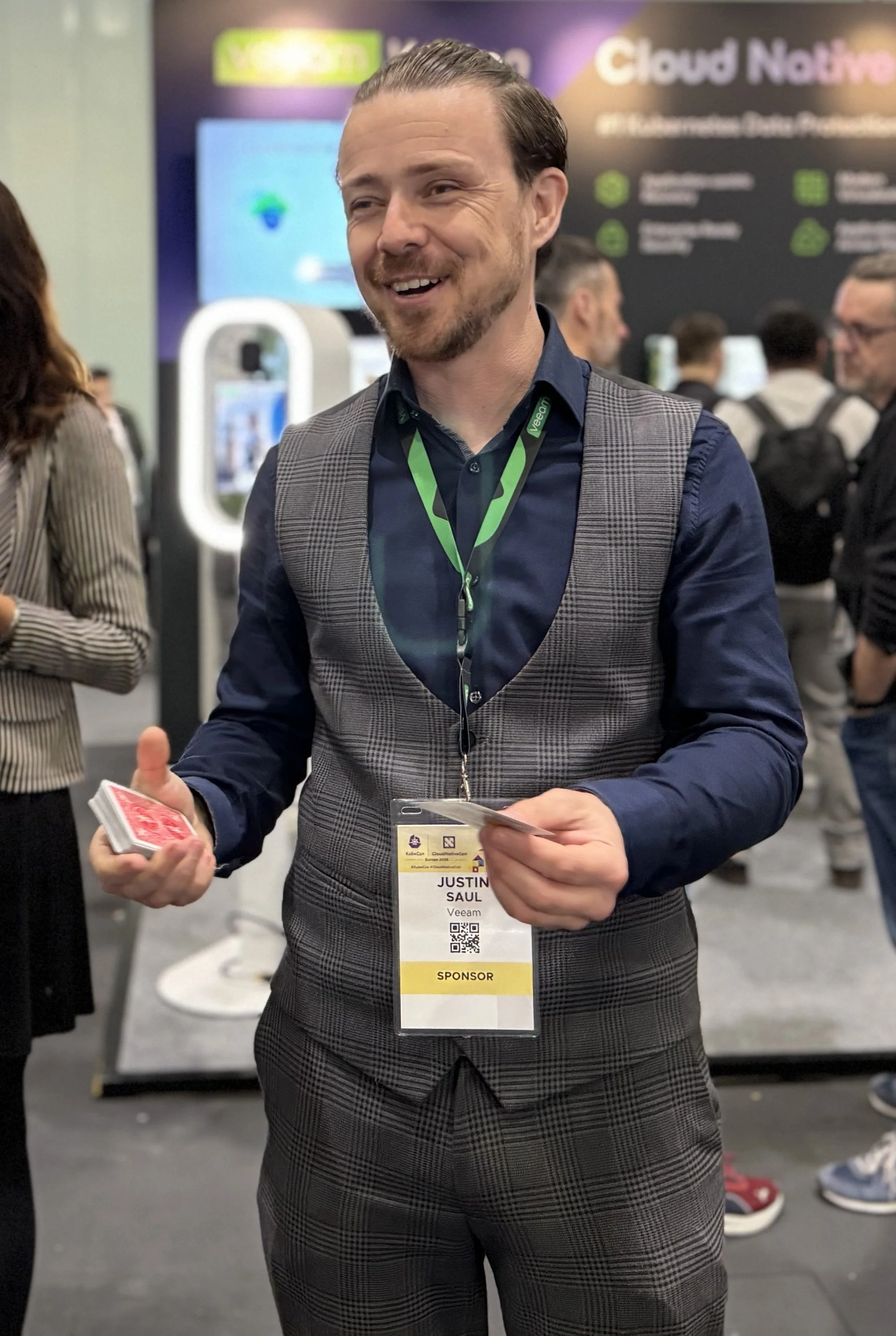 Trade show magician Just Saul performing a card trick on the exhibition floor