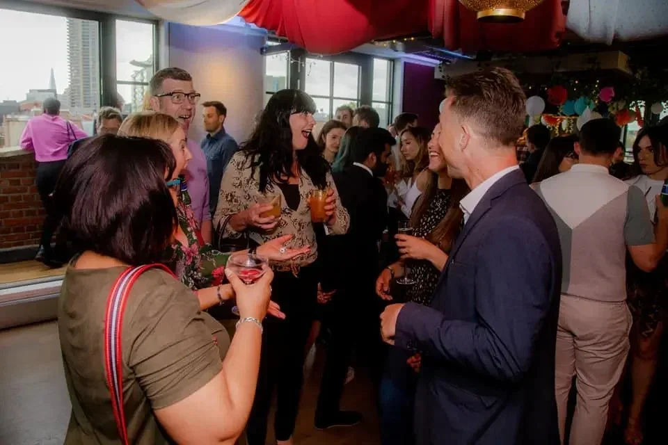 Saul performing close-up magic among guests at a corporate event